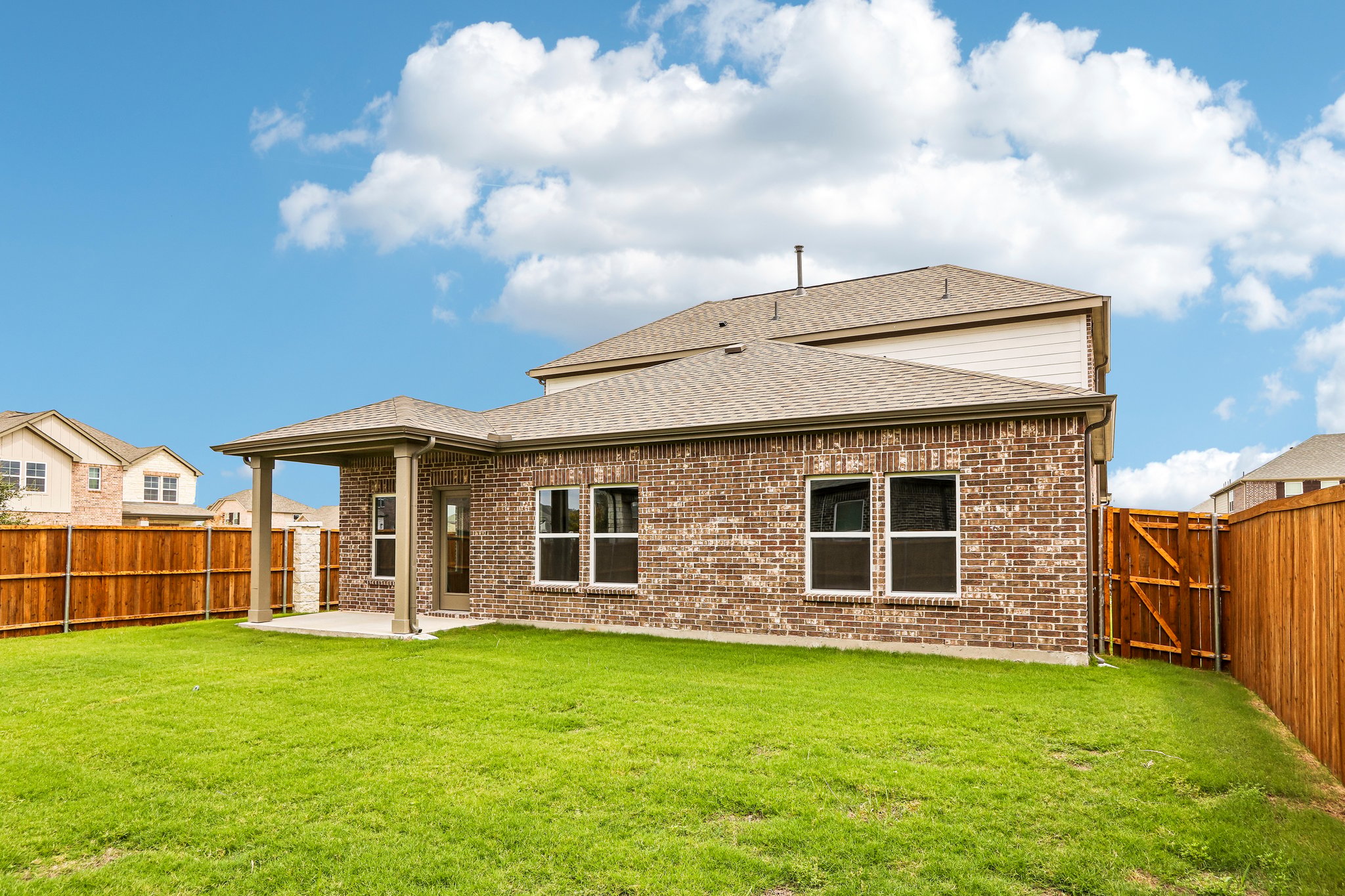A brick house with a fence.