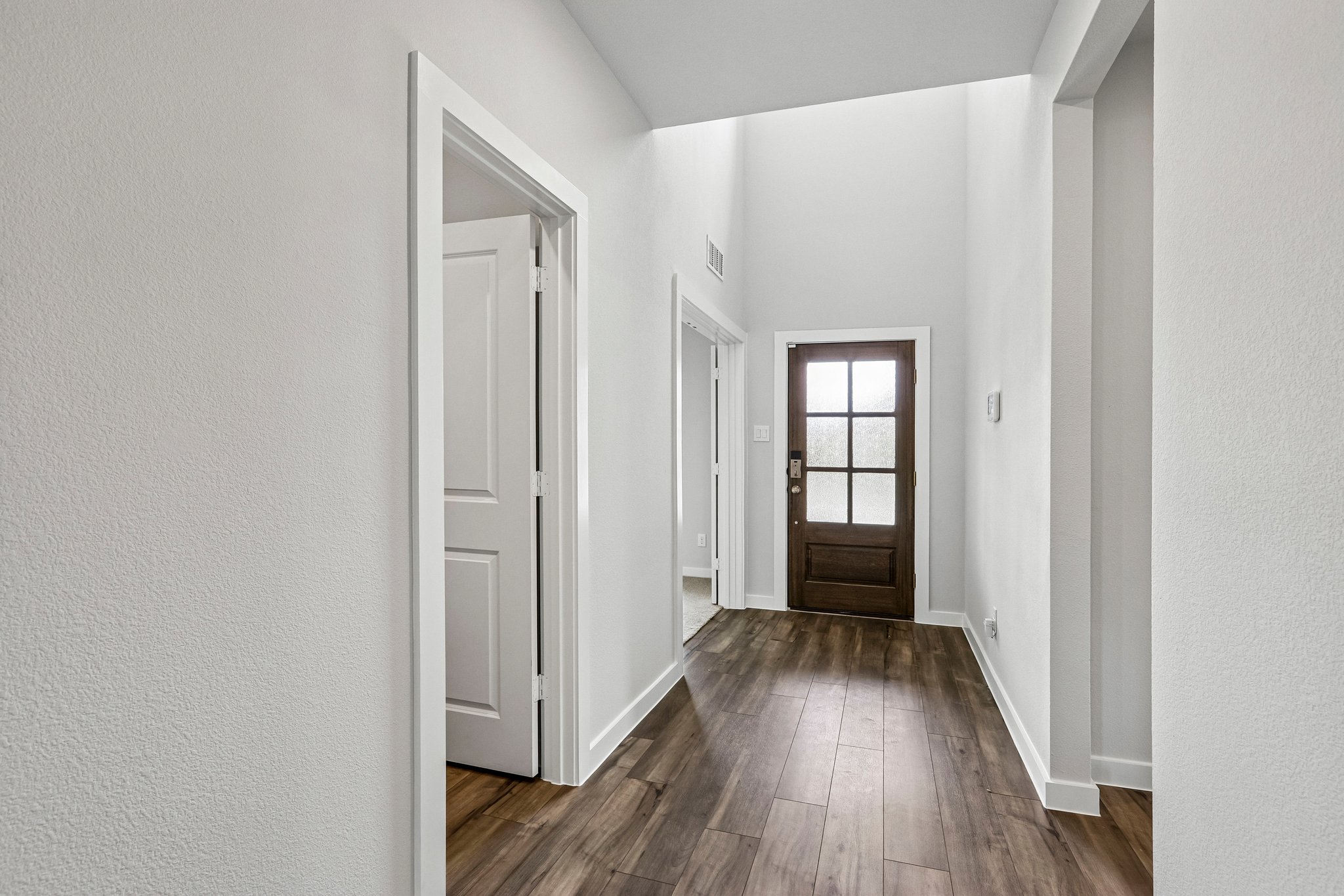 A hallway with white walls.