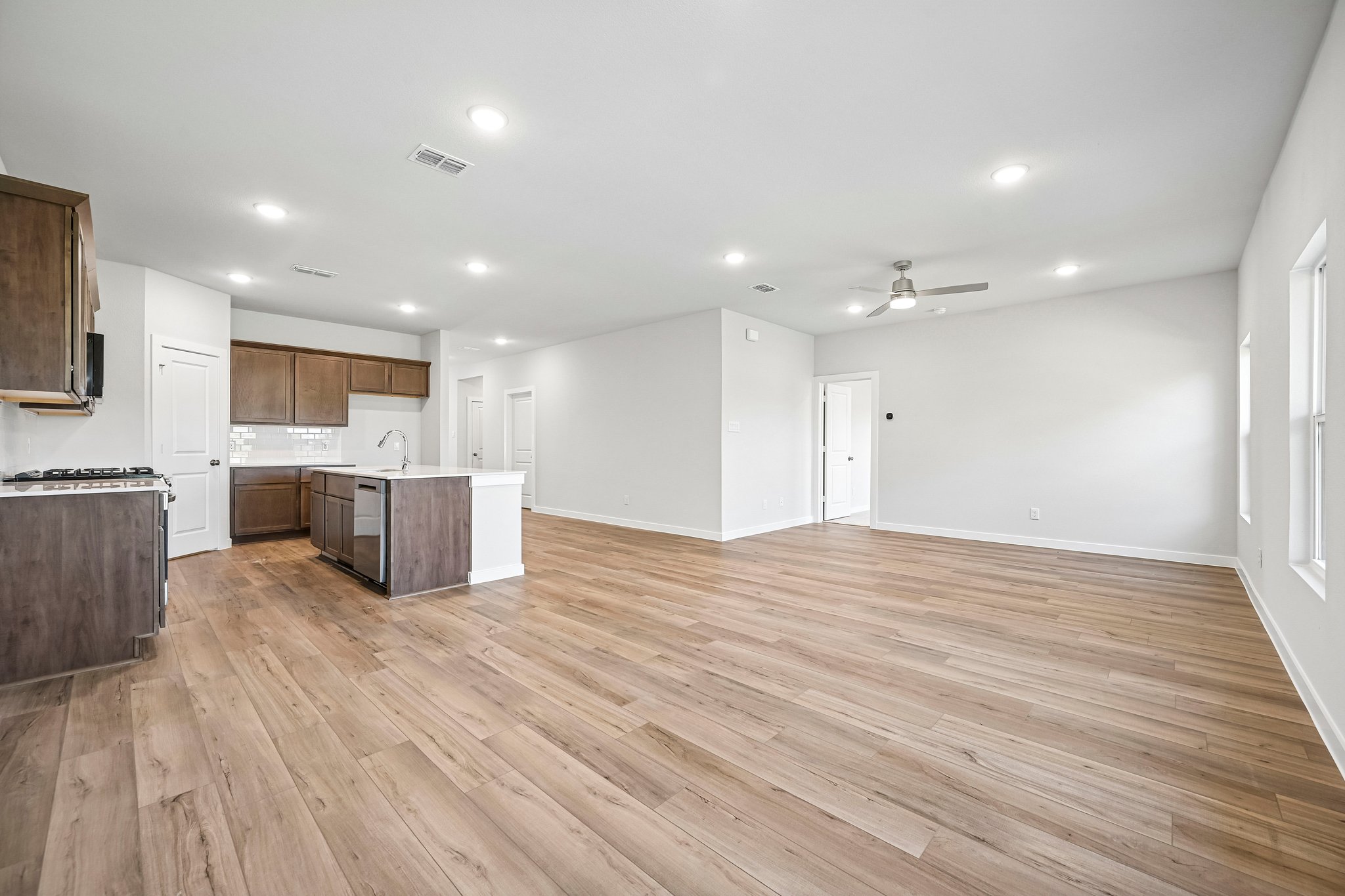 A large kitchen with wooden floors.