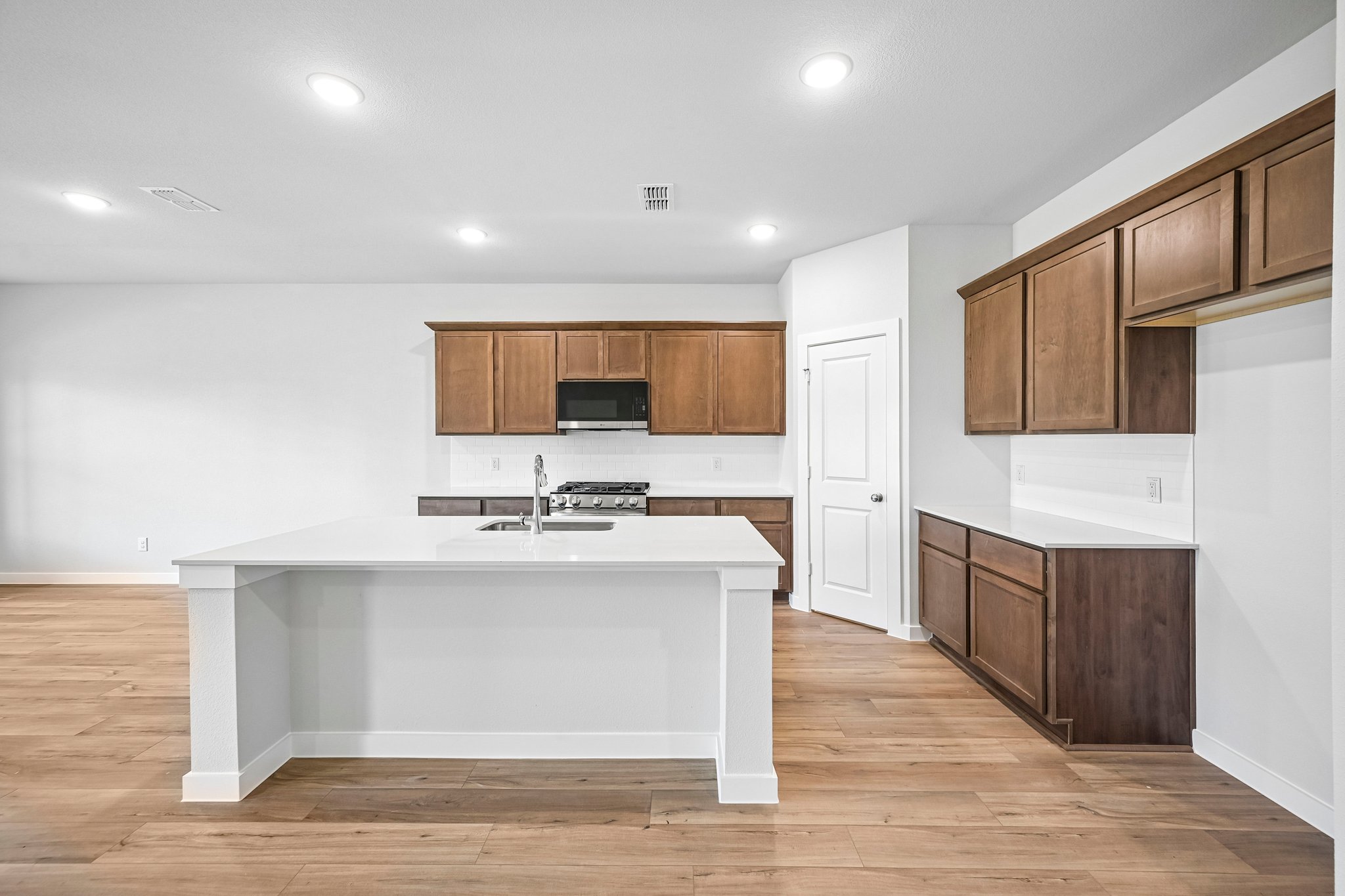 A kitchen with wooden cabinets.