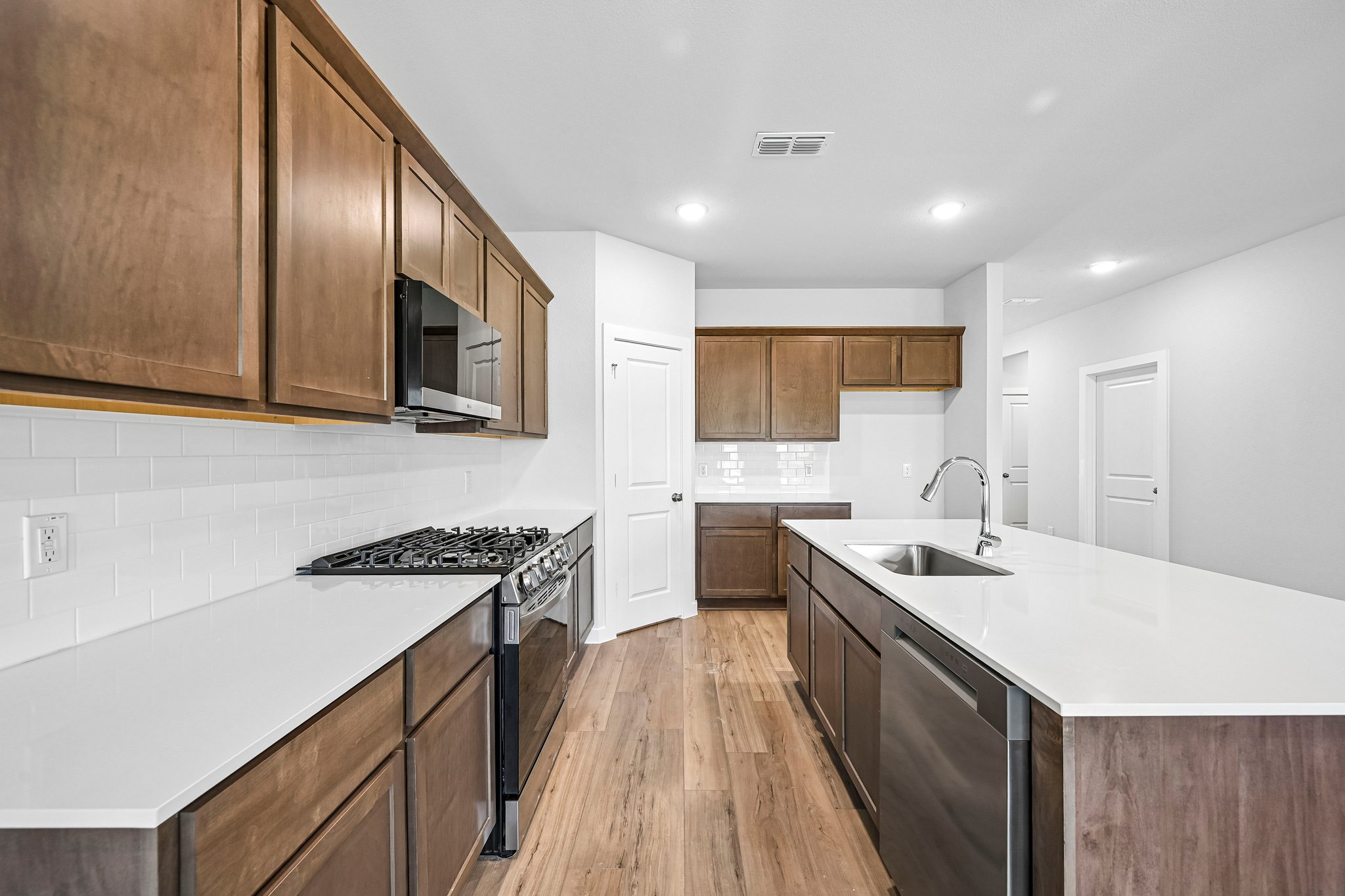 A kitchen with wooden cabinets.