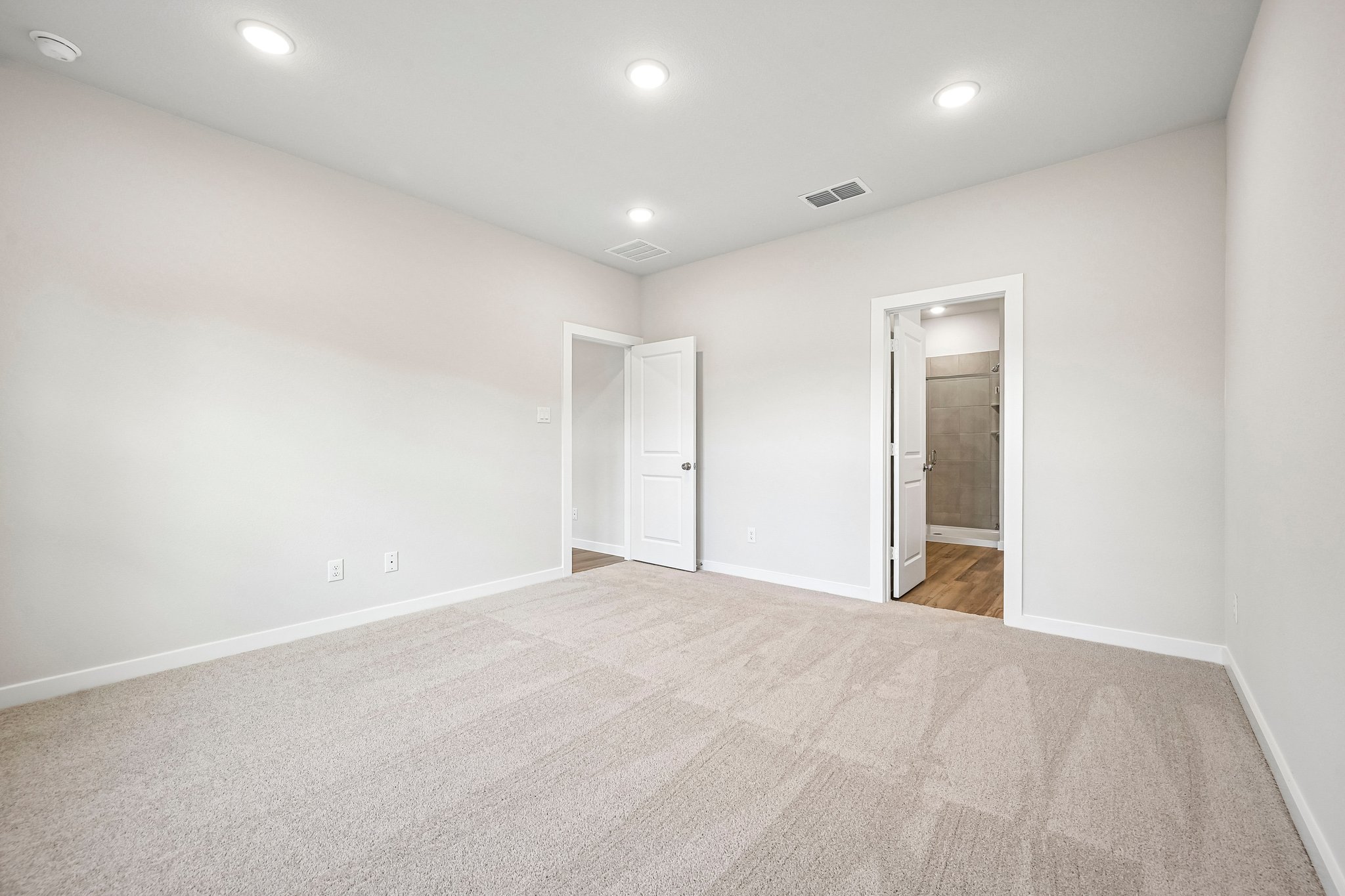 A hallway with white walls.