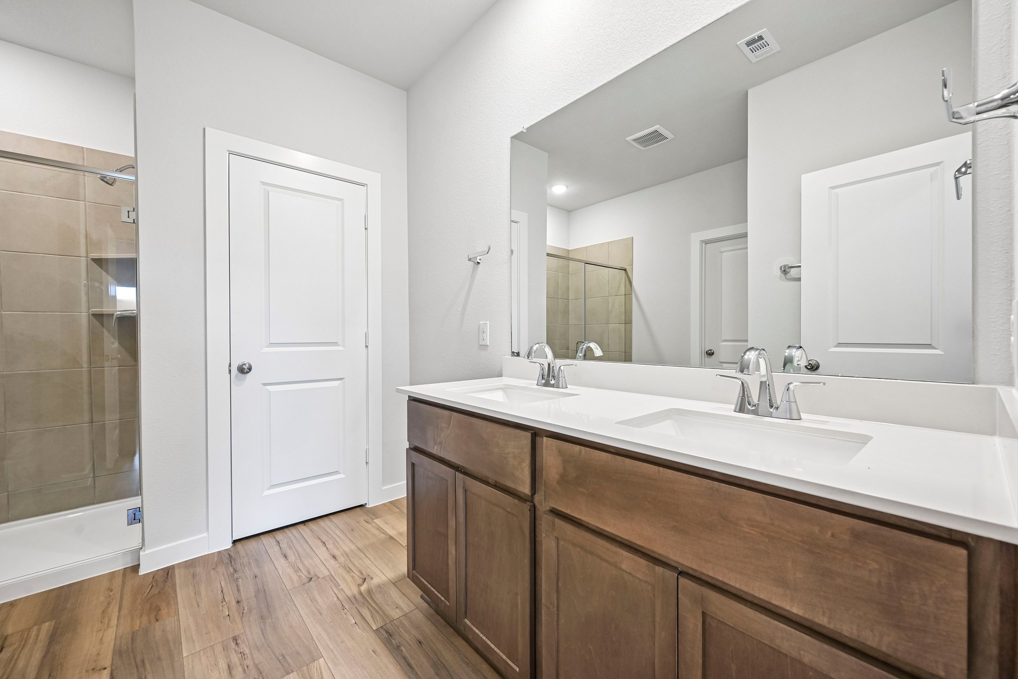 A bathroom with a large mirror.