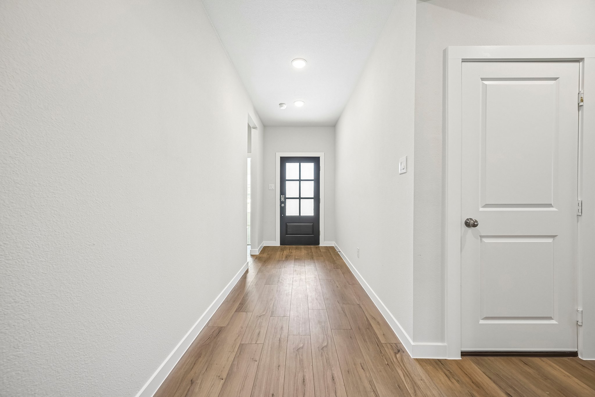 A hallway with white doors.
