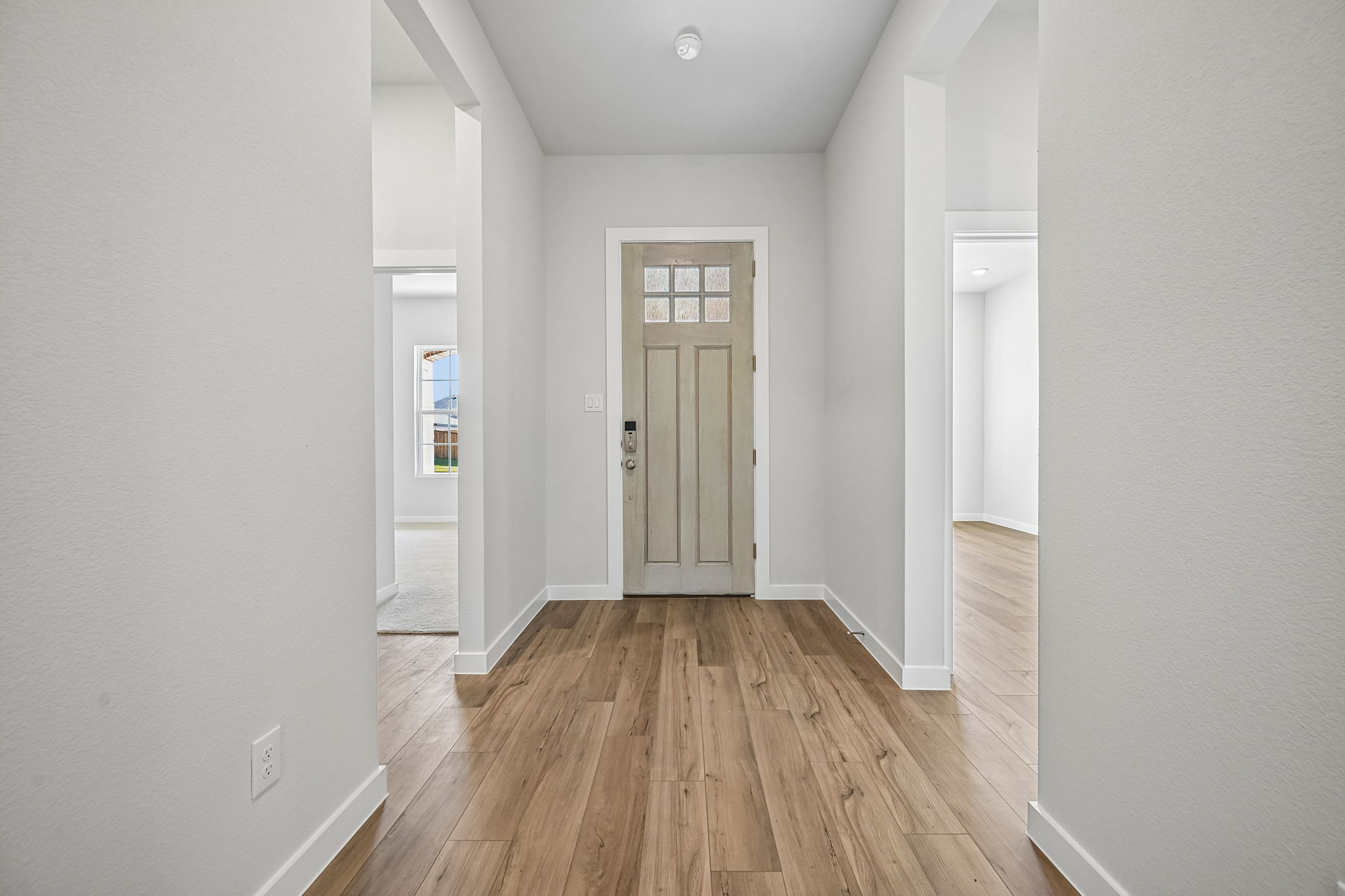 A hallway with white walls.