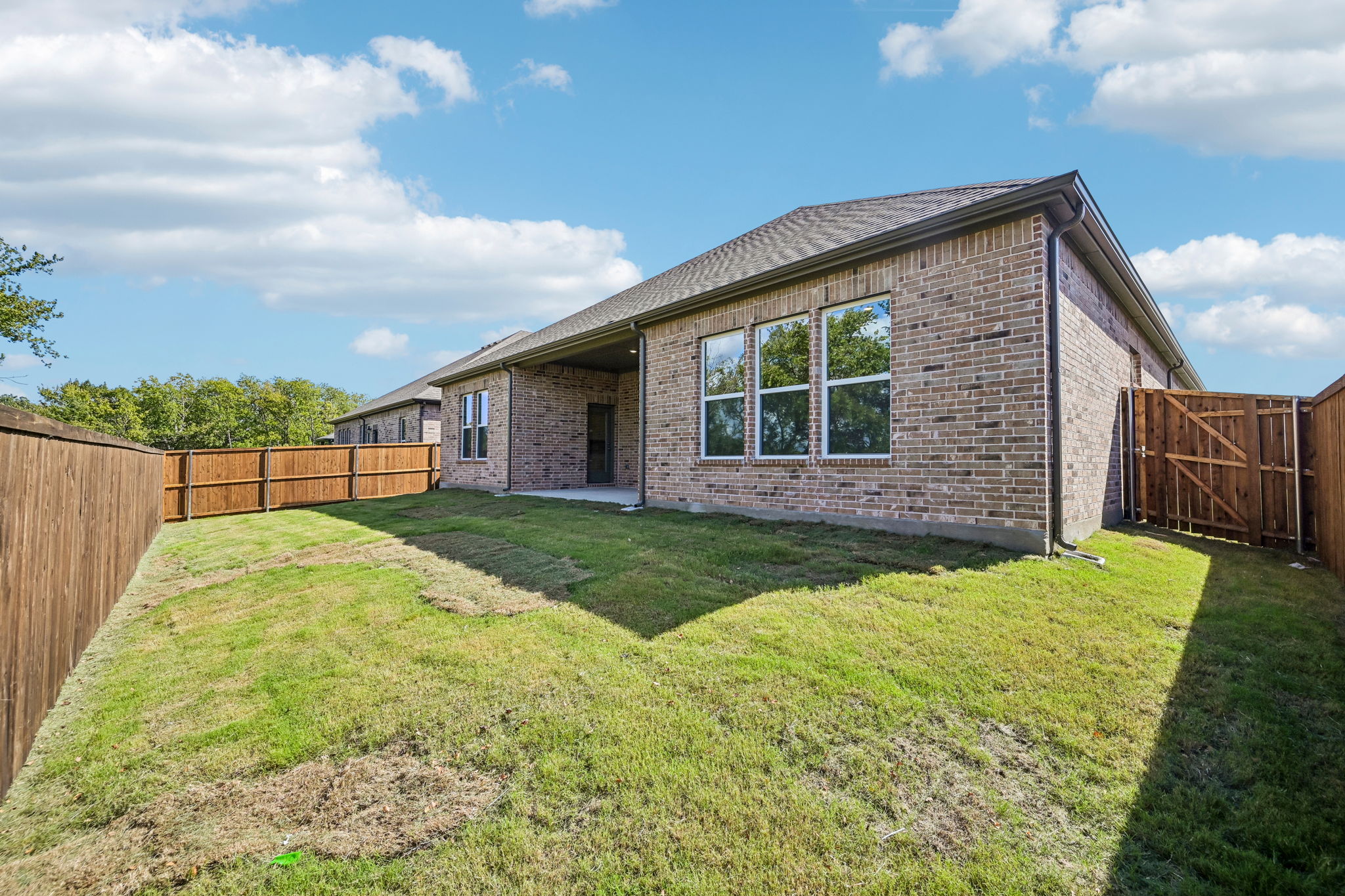 A house with a fence and grass.