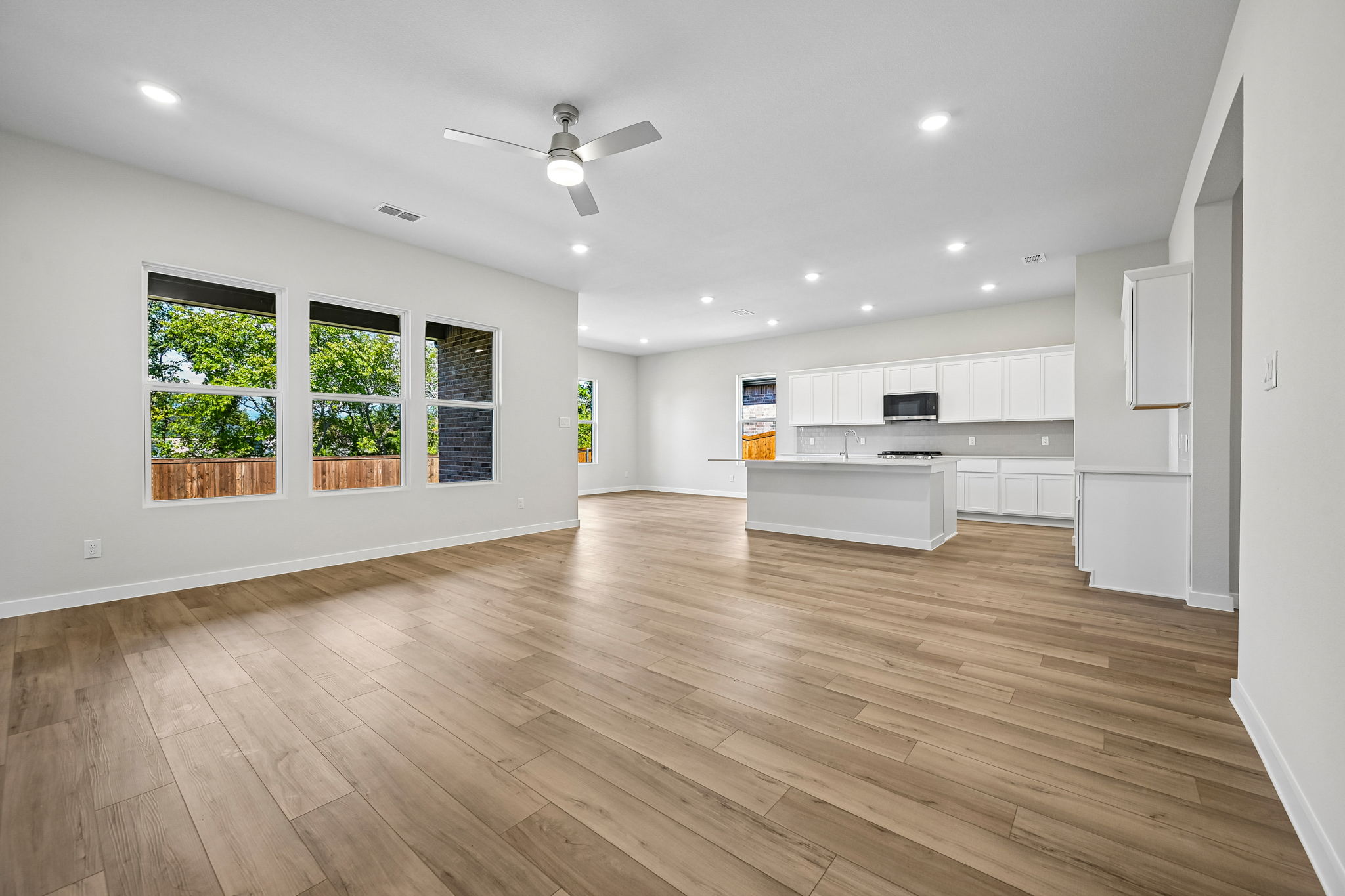 A large kitchen with white cabinets.