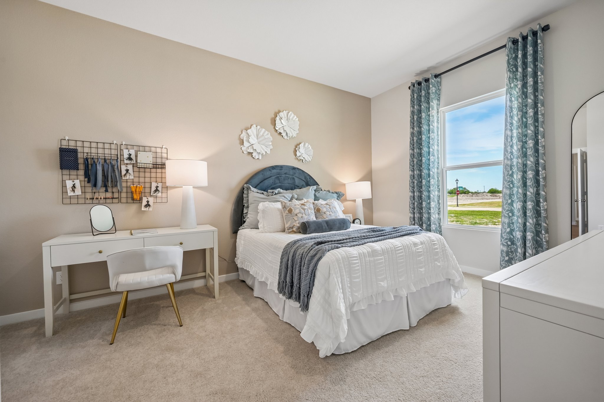 A bedroom with a bed and a table.