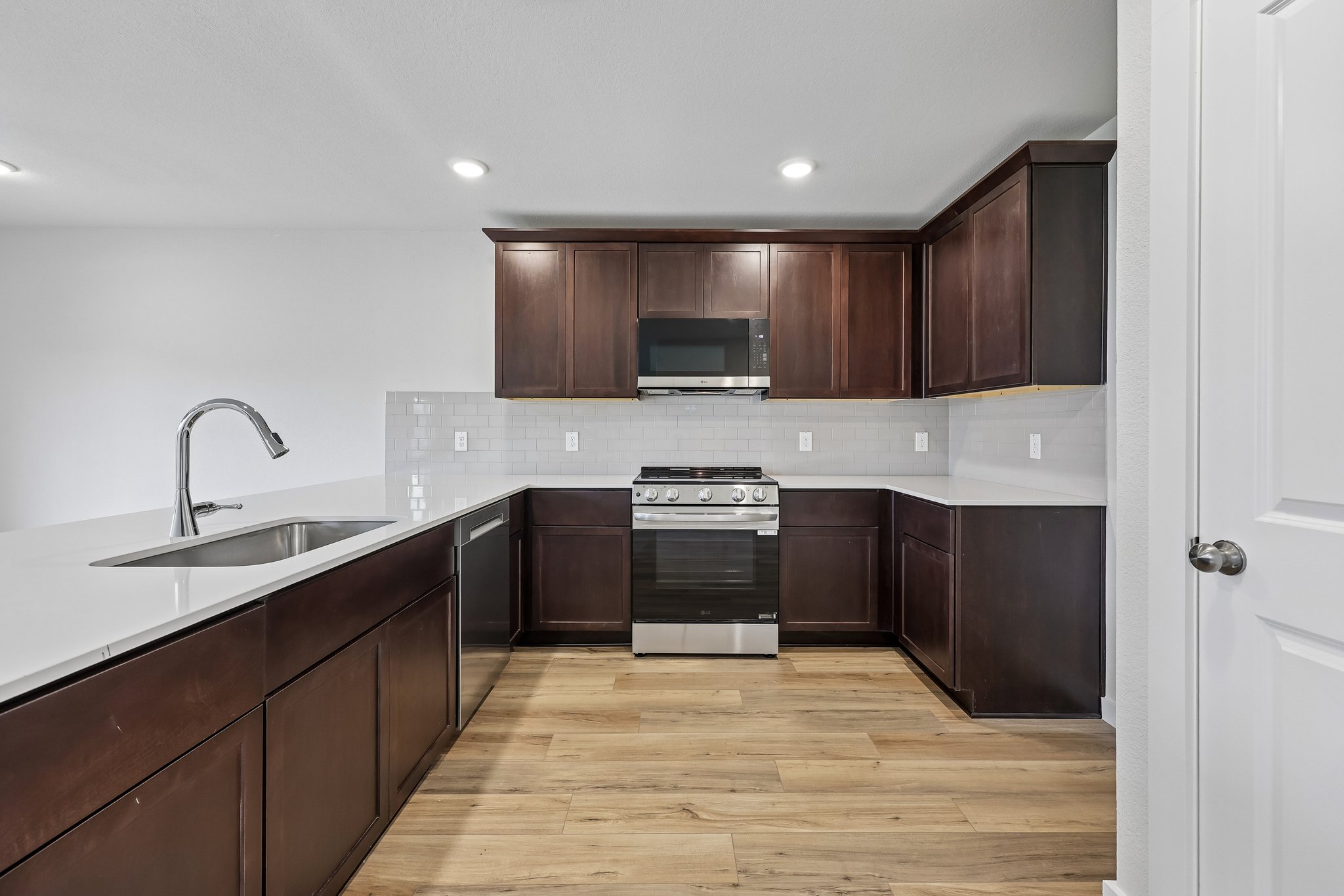 A kitchen with wooden cabinets.