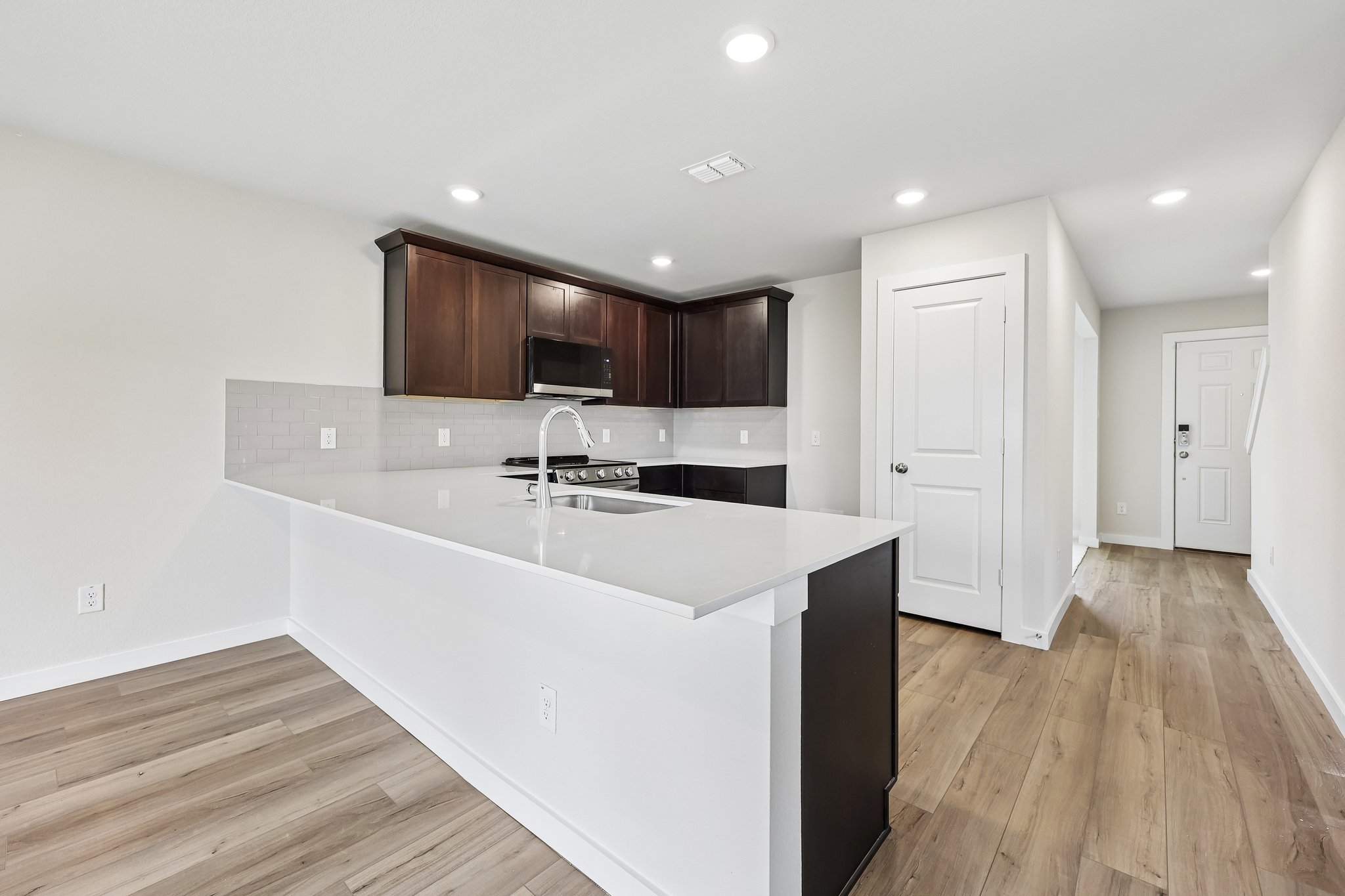 A kitchen with white cabinets.