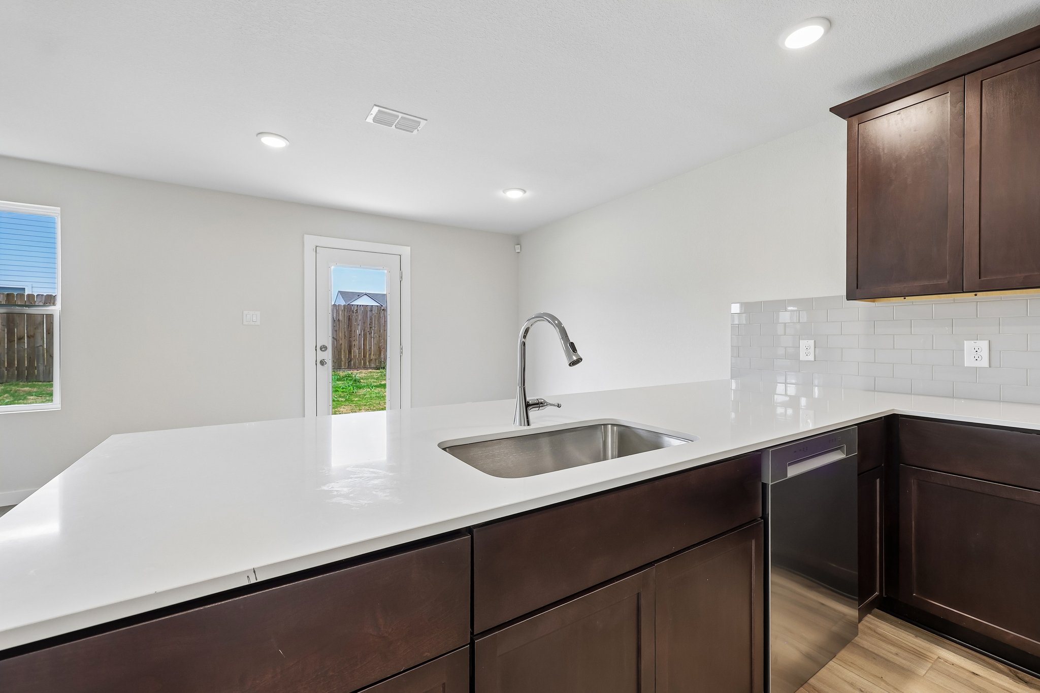 A kitchen with a sink and cabinets.