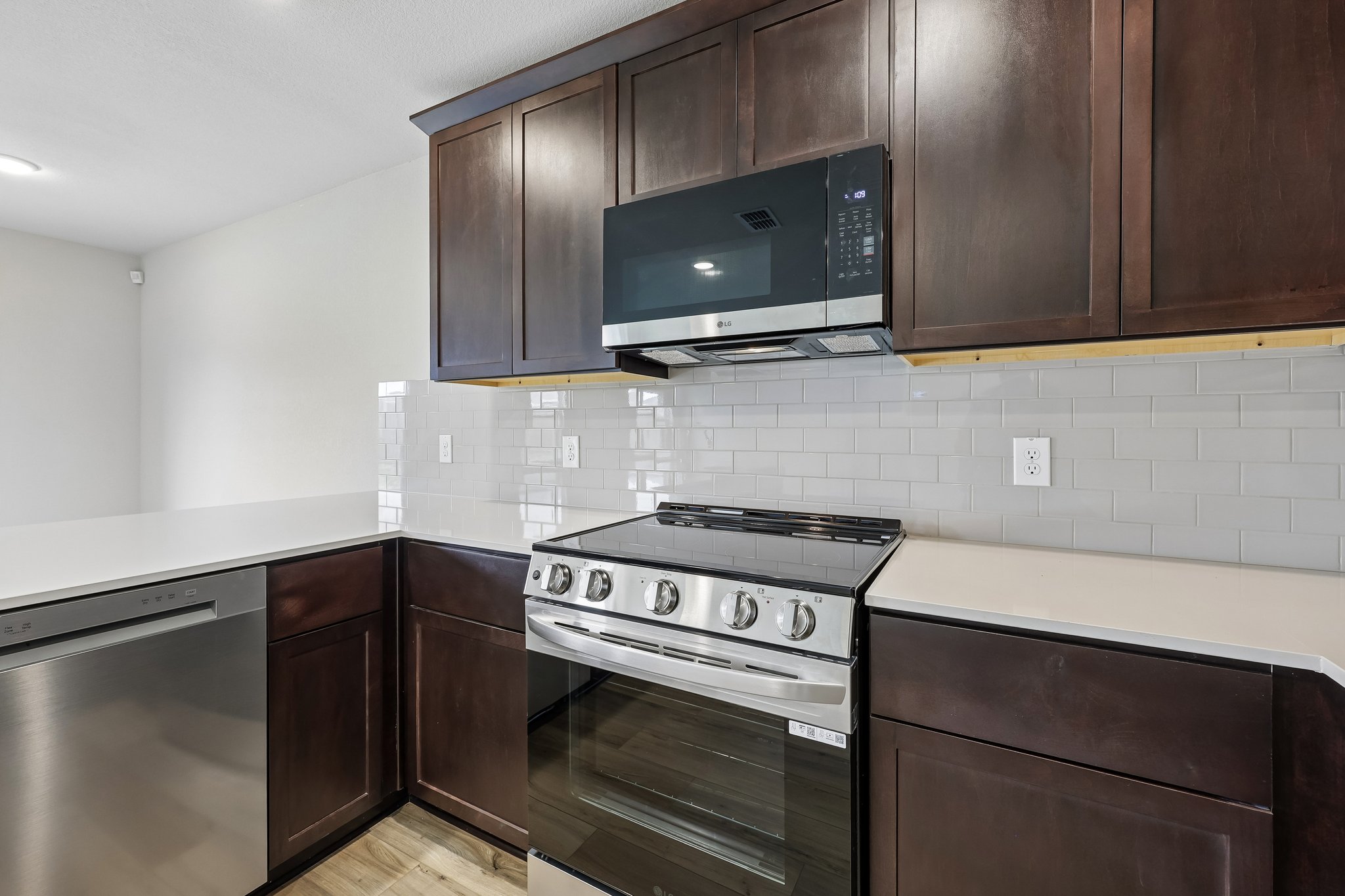 A kitchen with wooden cabinets.
