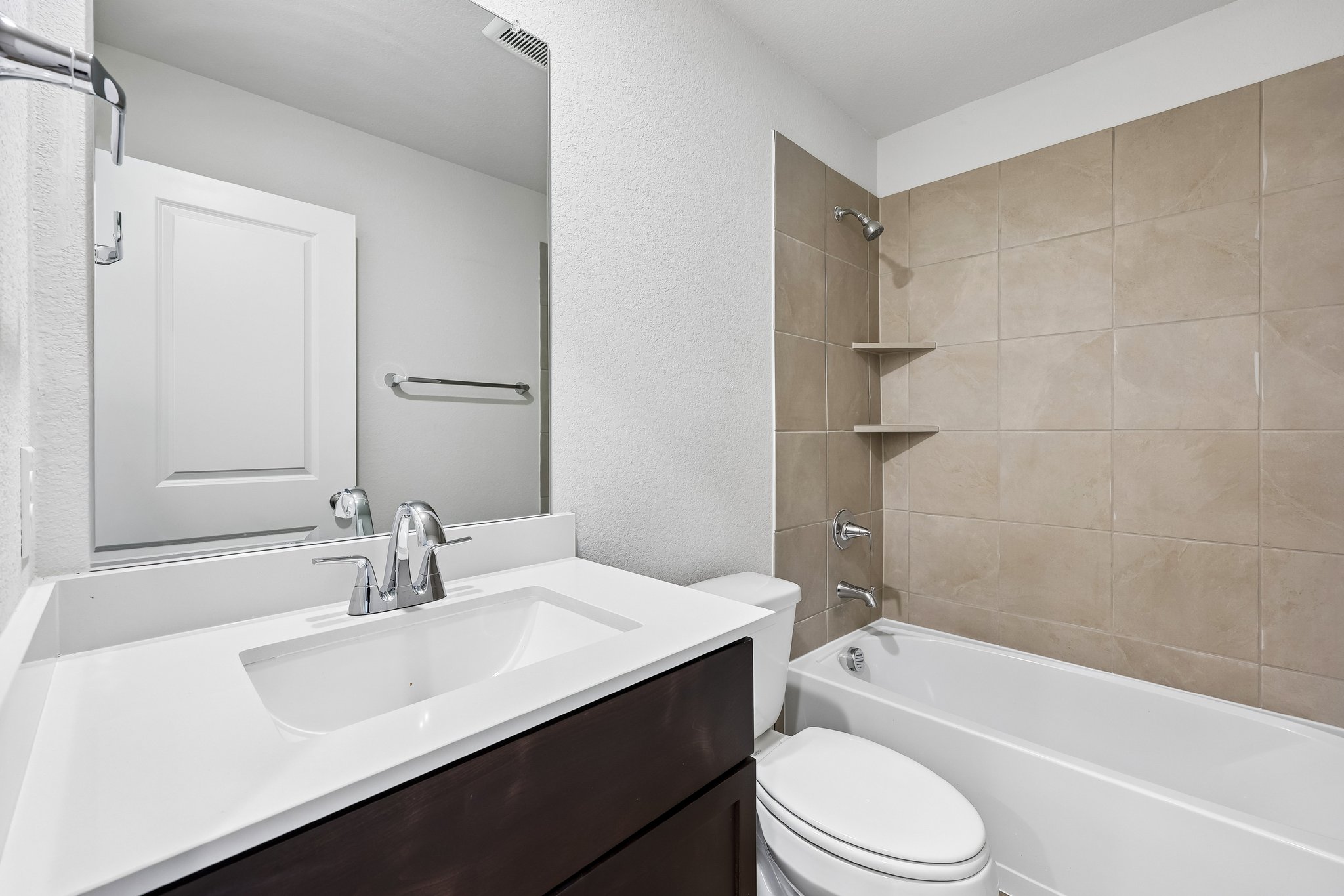 A bathroom with a sink and a toilet.