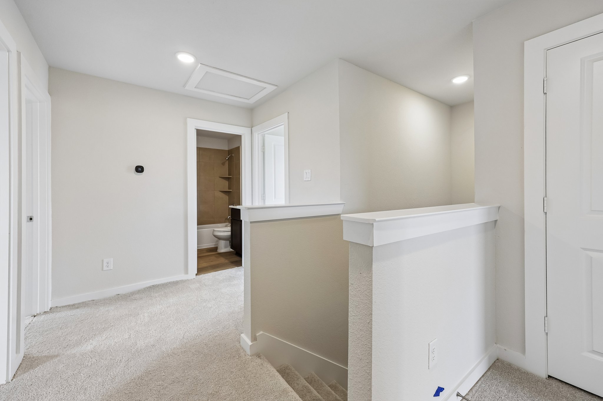 A bathroom with white walls.