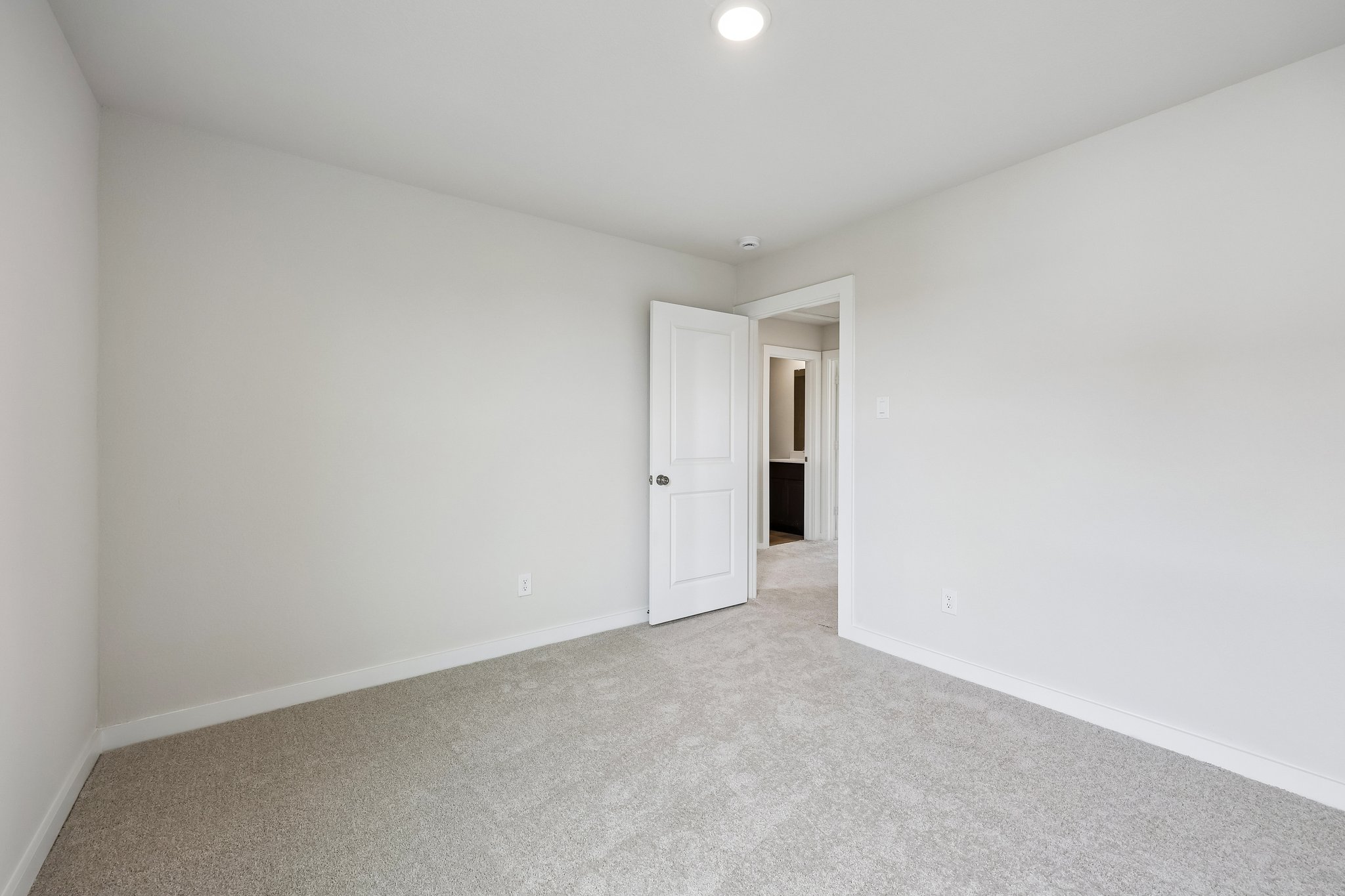 A hallway with white walls.