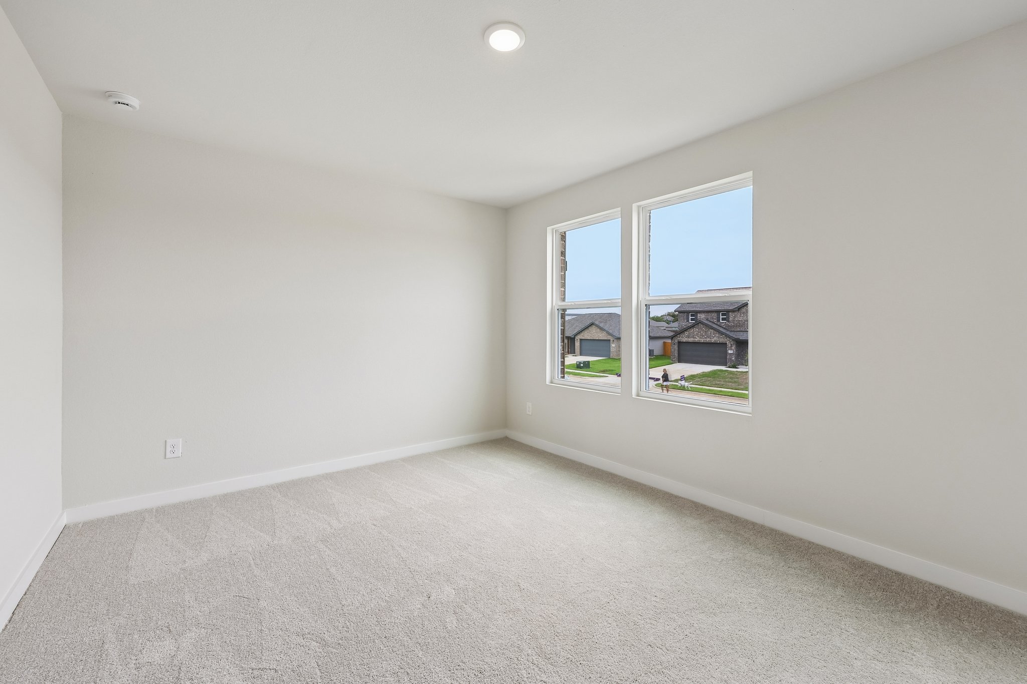 A room with a window and a view of the water.