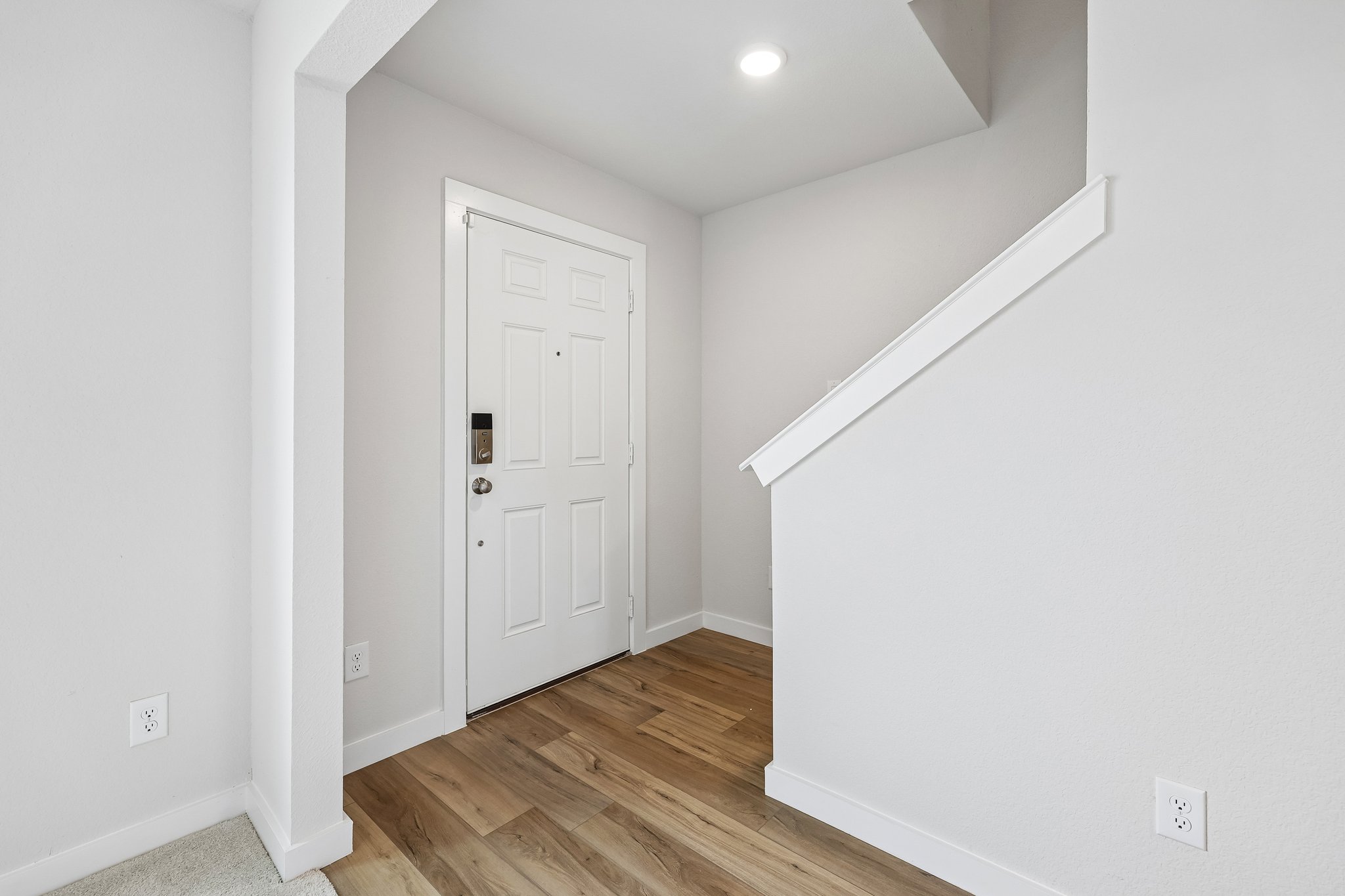 A hallway with white walls.
