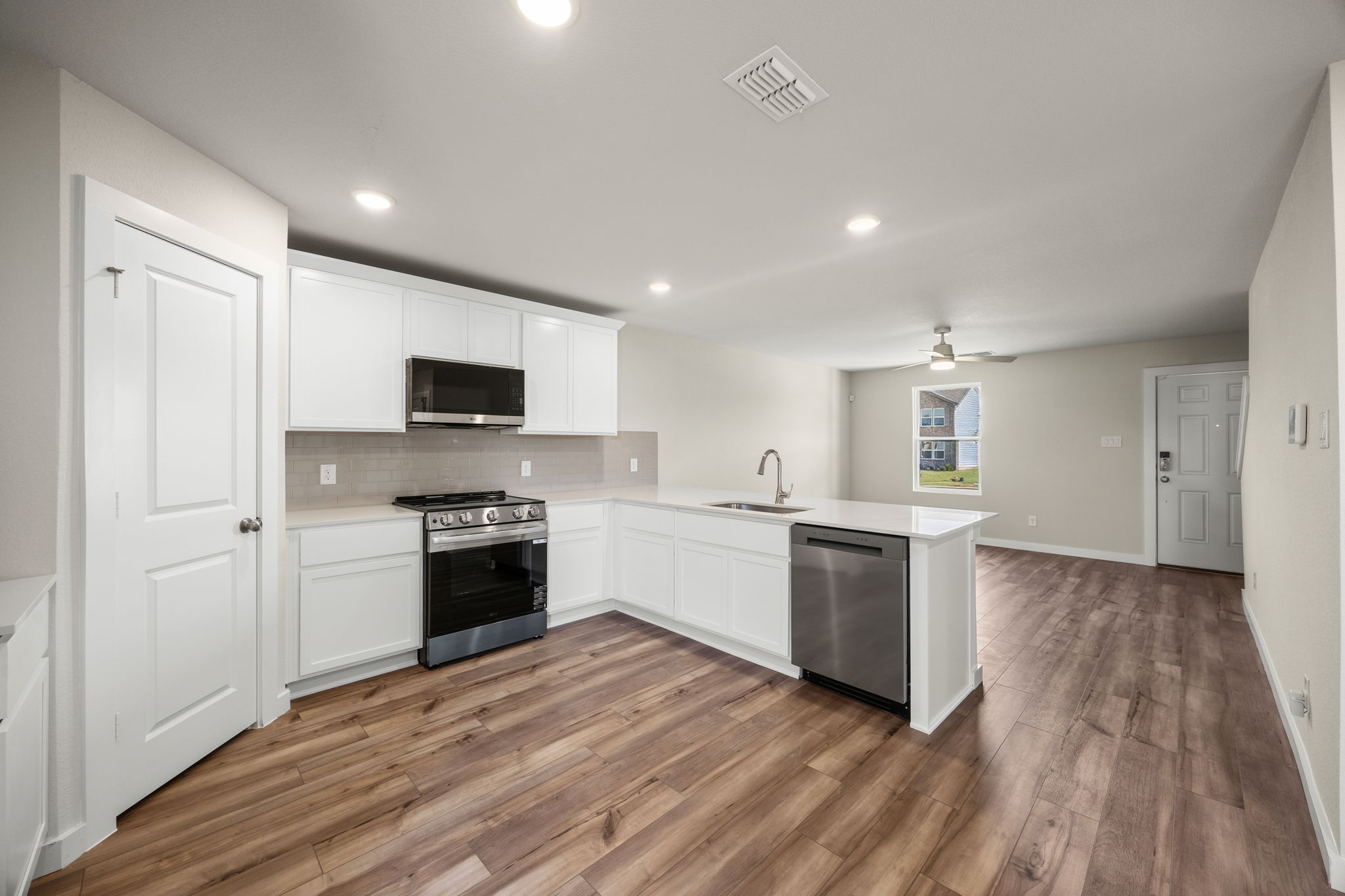 A kitchen with white cabinets.