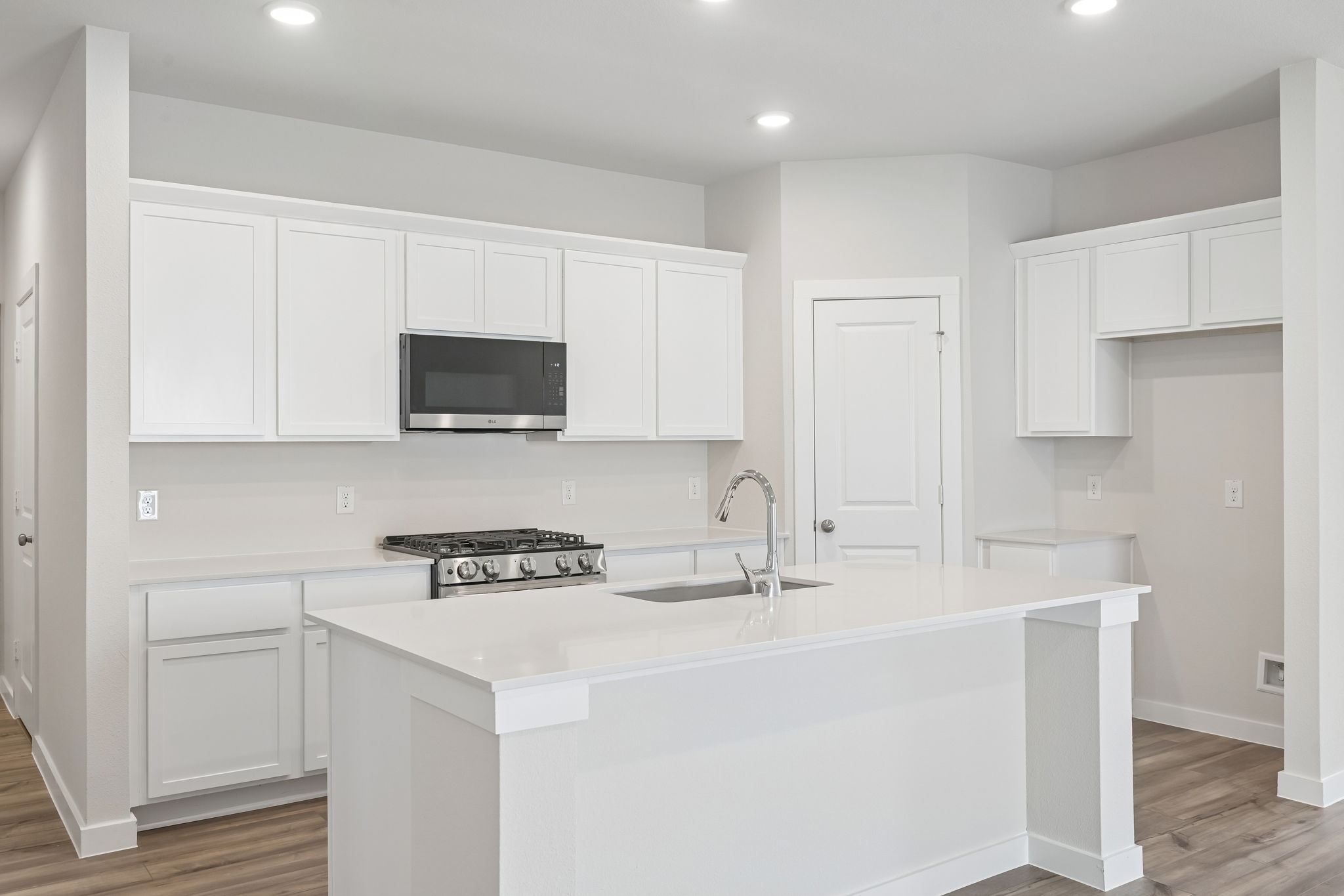 A kitchen with white cabinets.