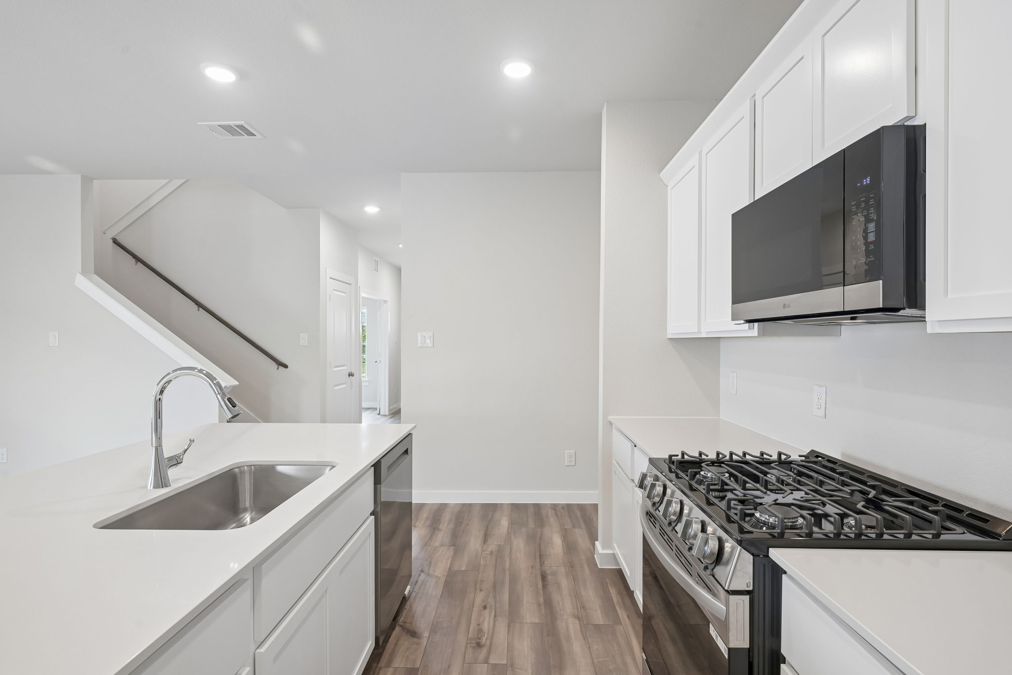 A kitchen with white cabinets.
