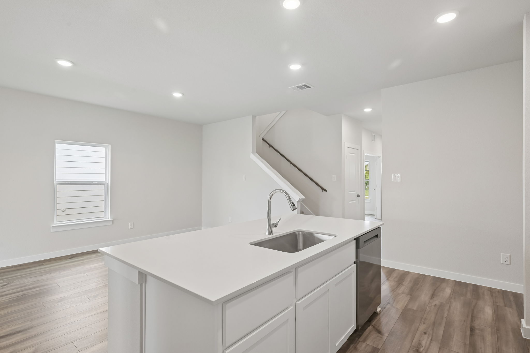 A kitchen with white cabinets.