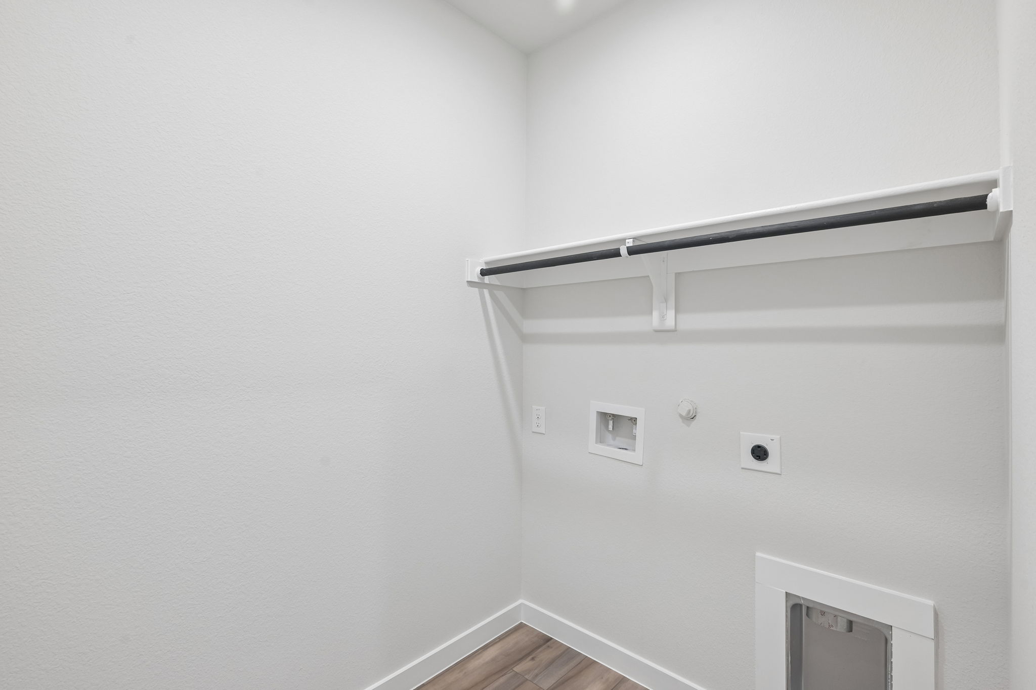 A white wall with a shelf.
