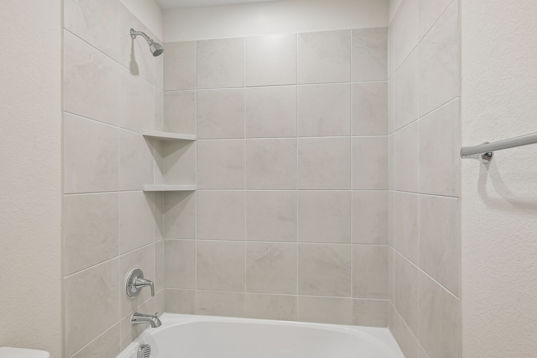 A bathtub in a bathroom.