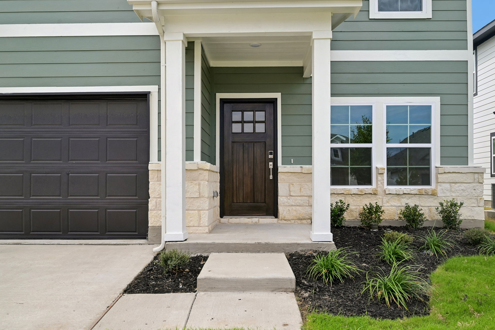 A house with a garage and a door.