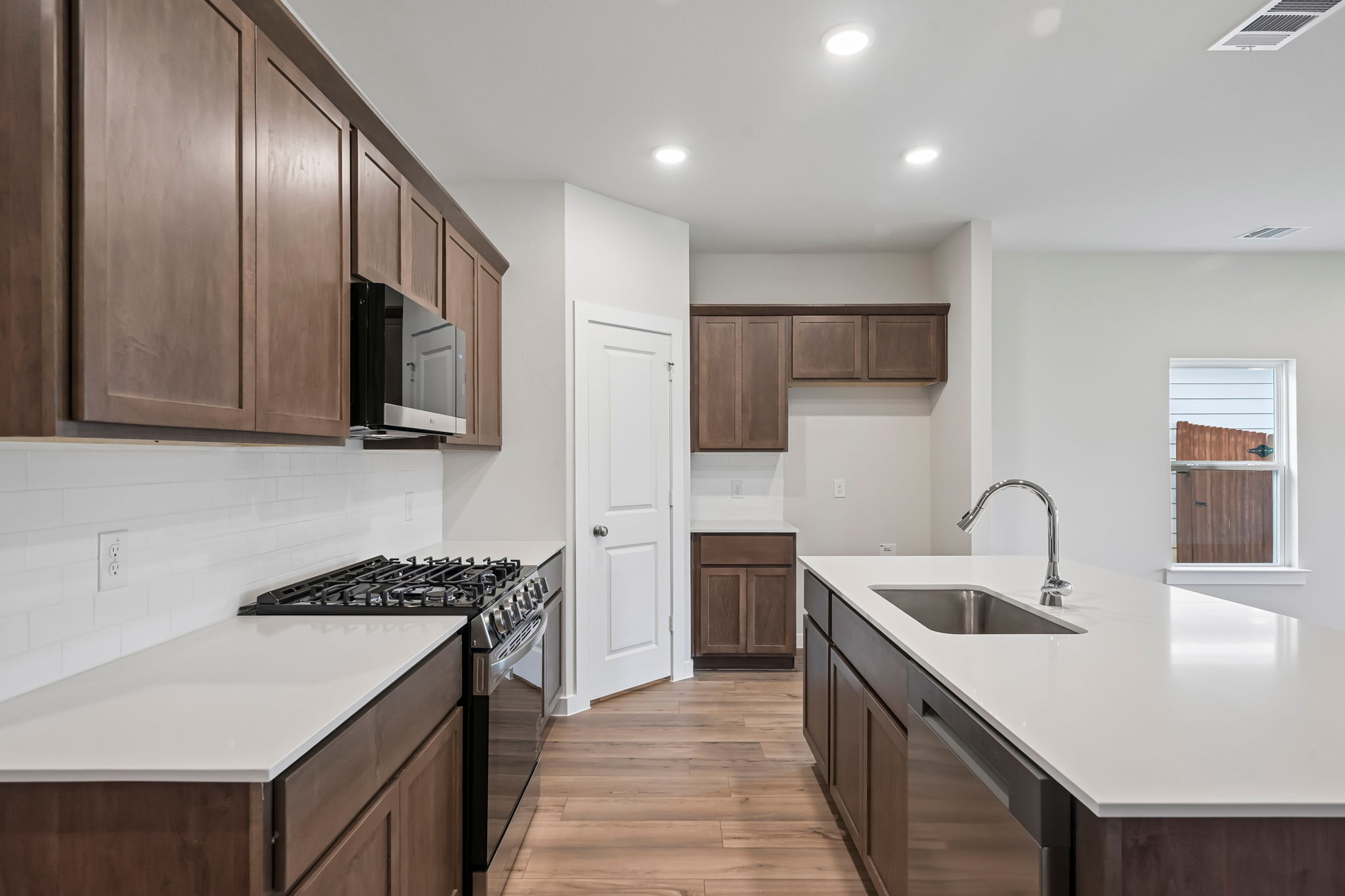 A kitchen with wooden cabinets.