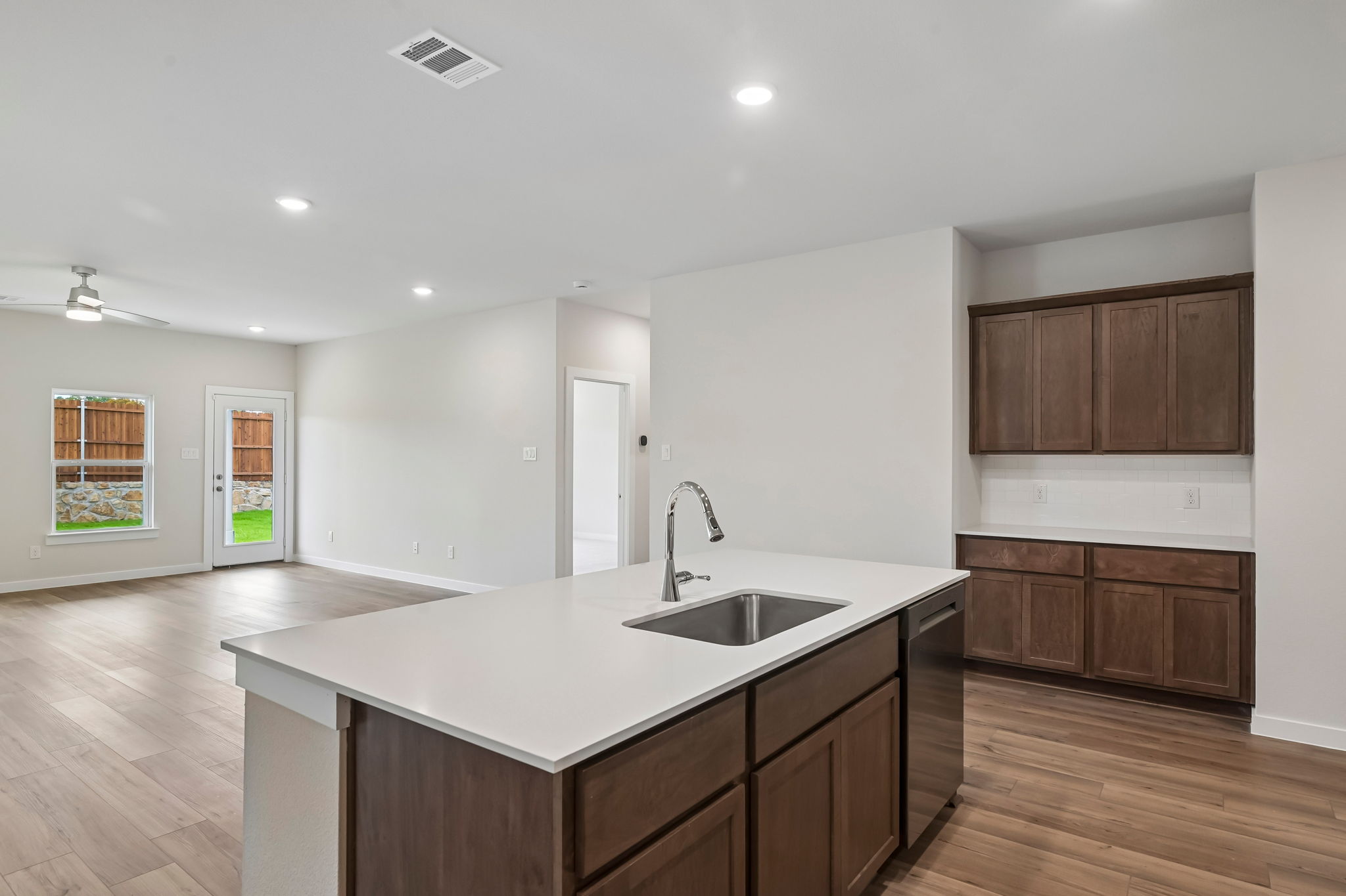 A kitchen with wooden cabinets.