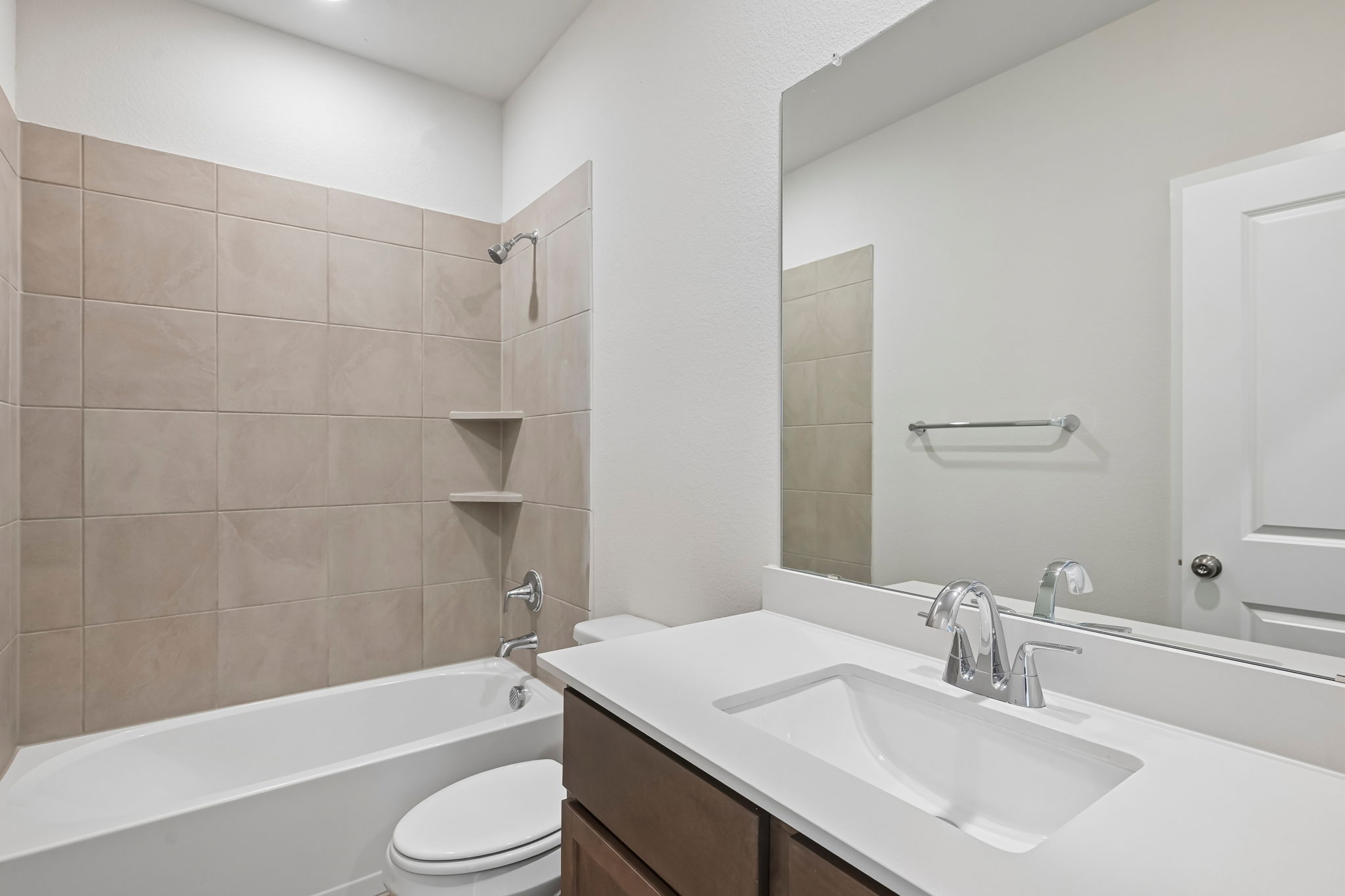 A bathroom with a tub sink and toilet.