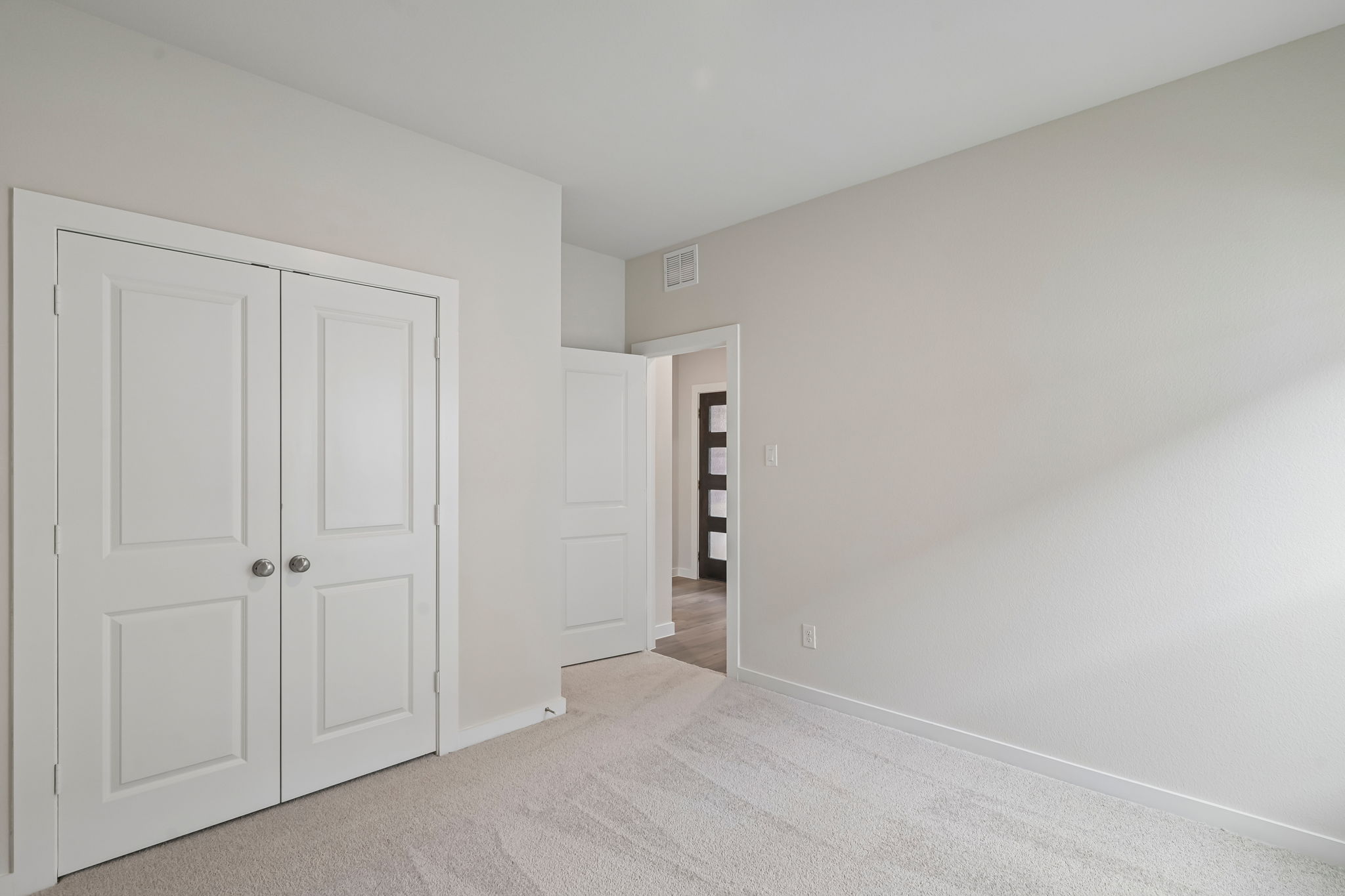 A hallway with white doors.