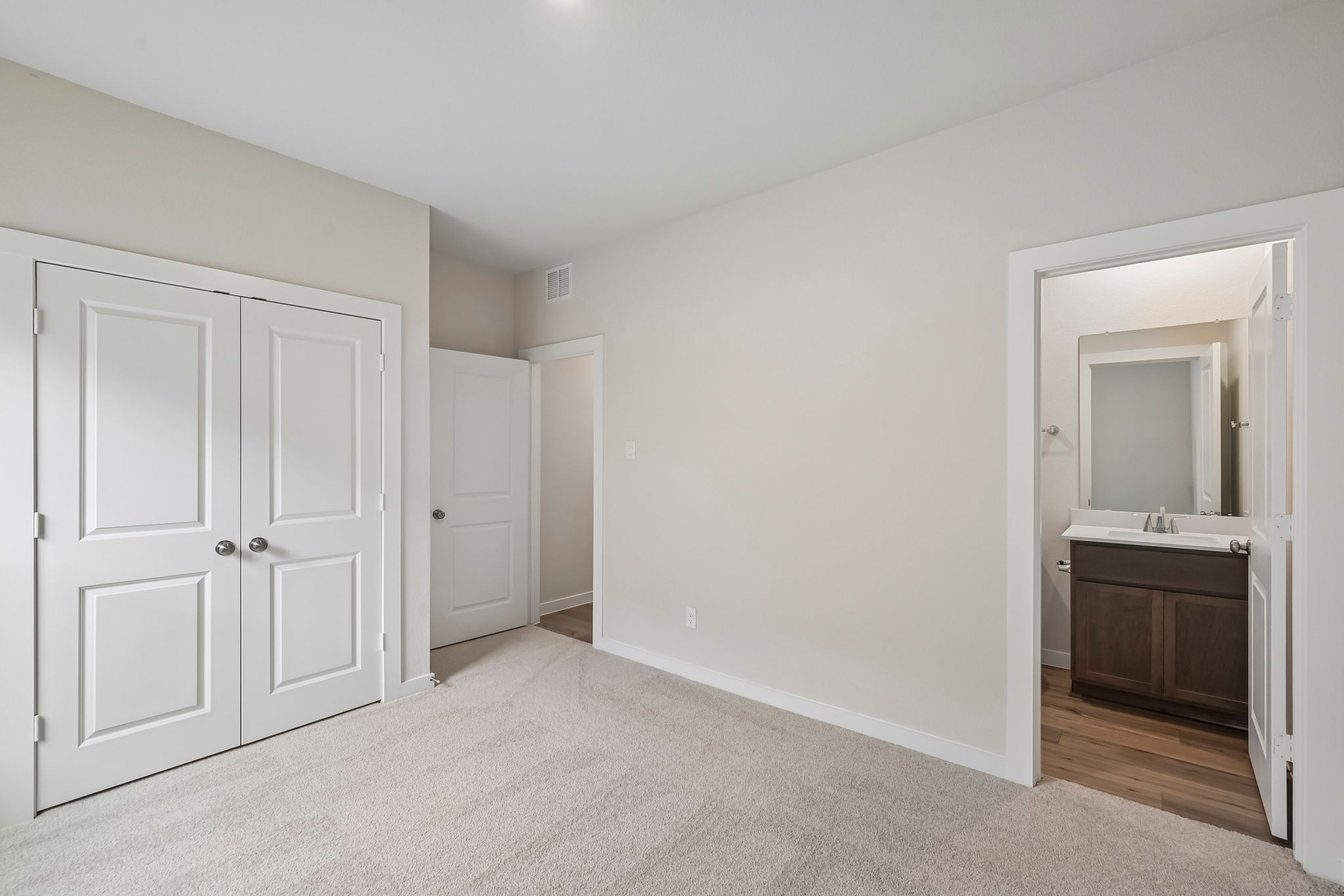 A bathroom with white doors.