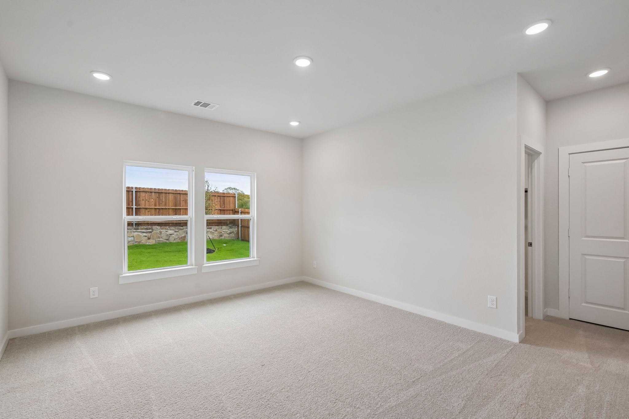 A room with a window and a door.
