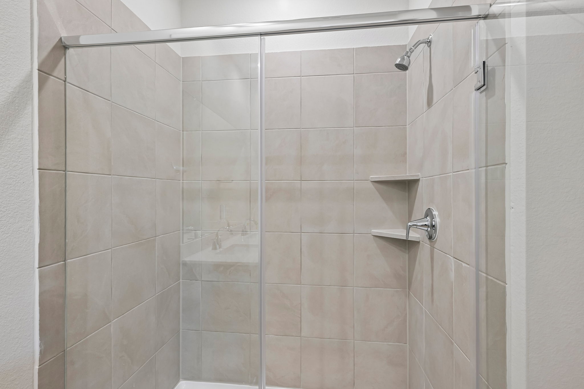 A shower with a glass door.