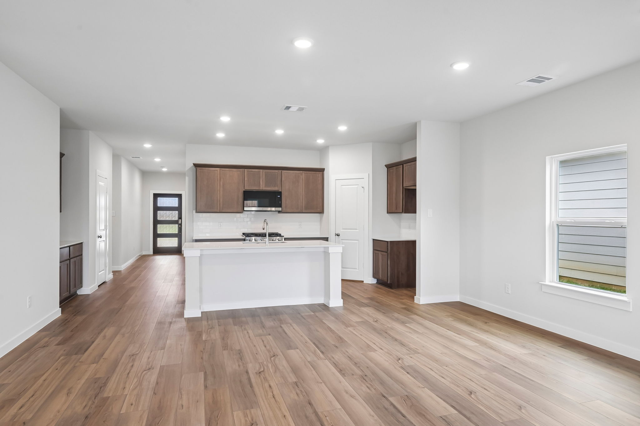 A large kitchen with white cabinets.