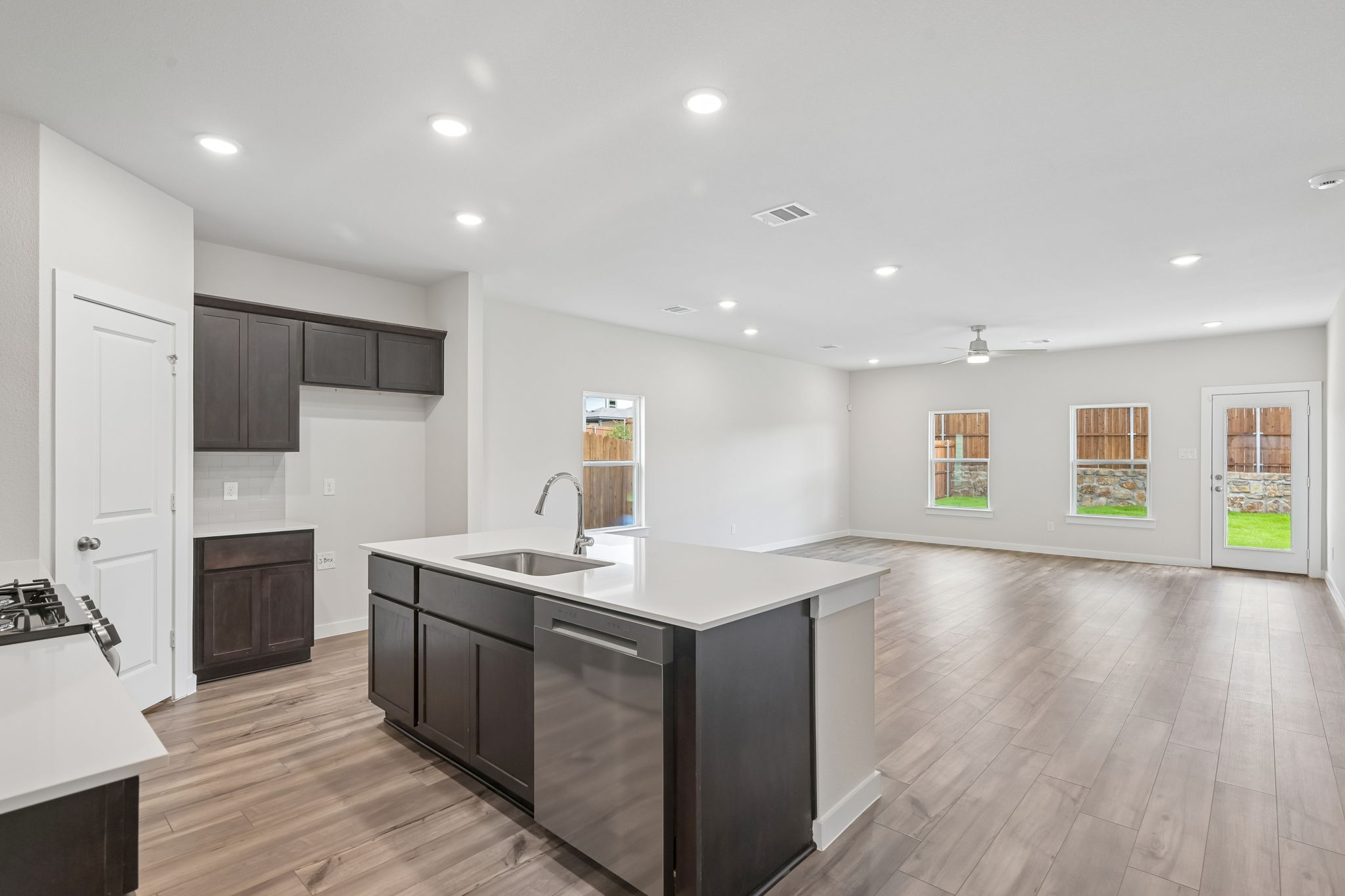 A kitchen with black cabinets.