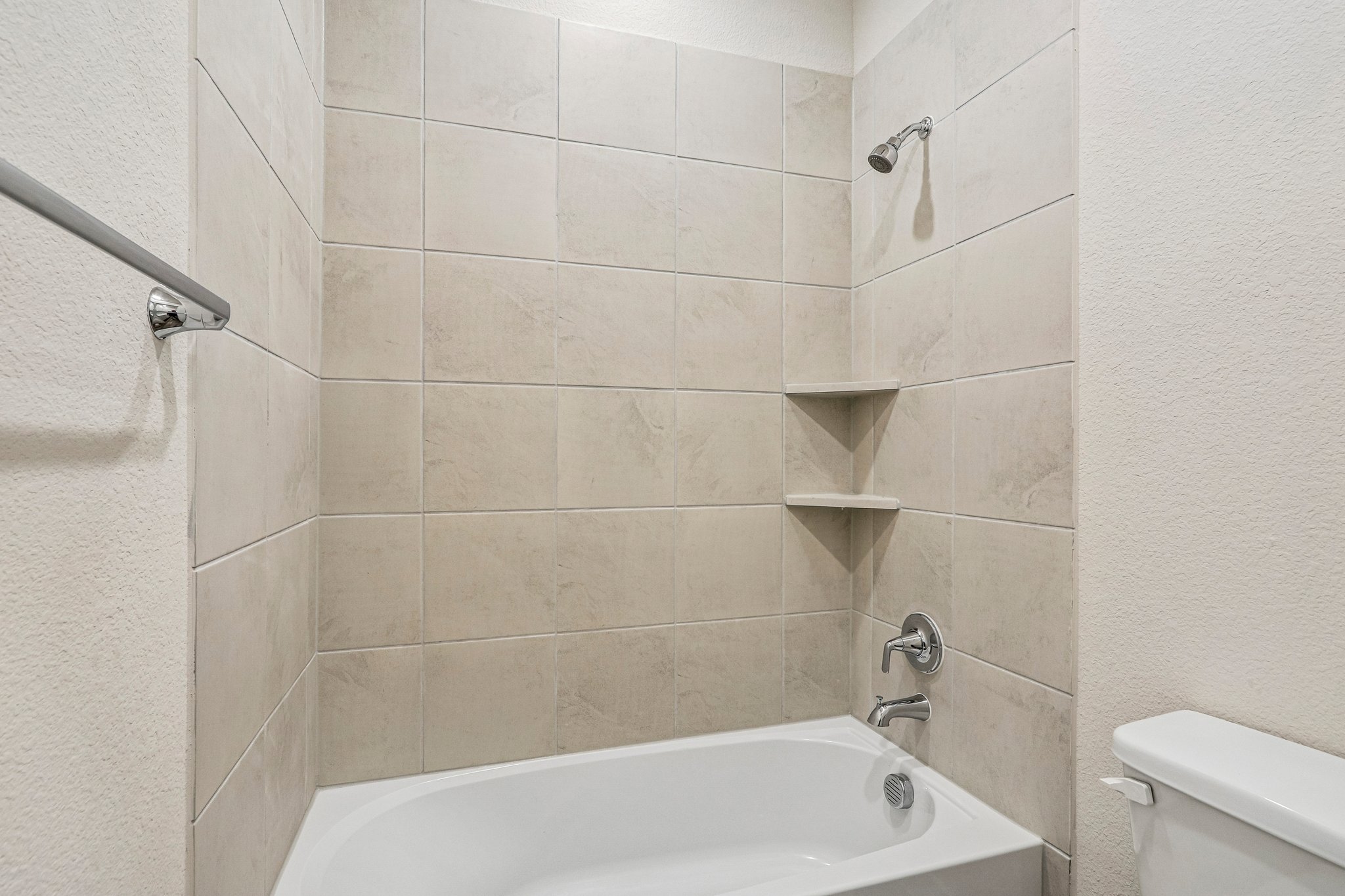 A bathtub in a bathroom.