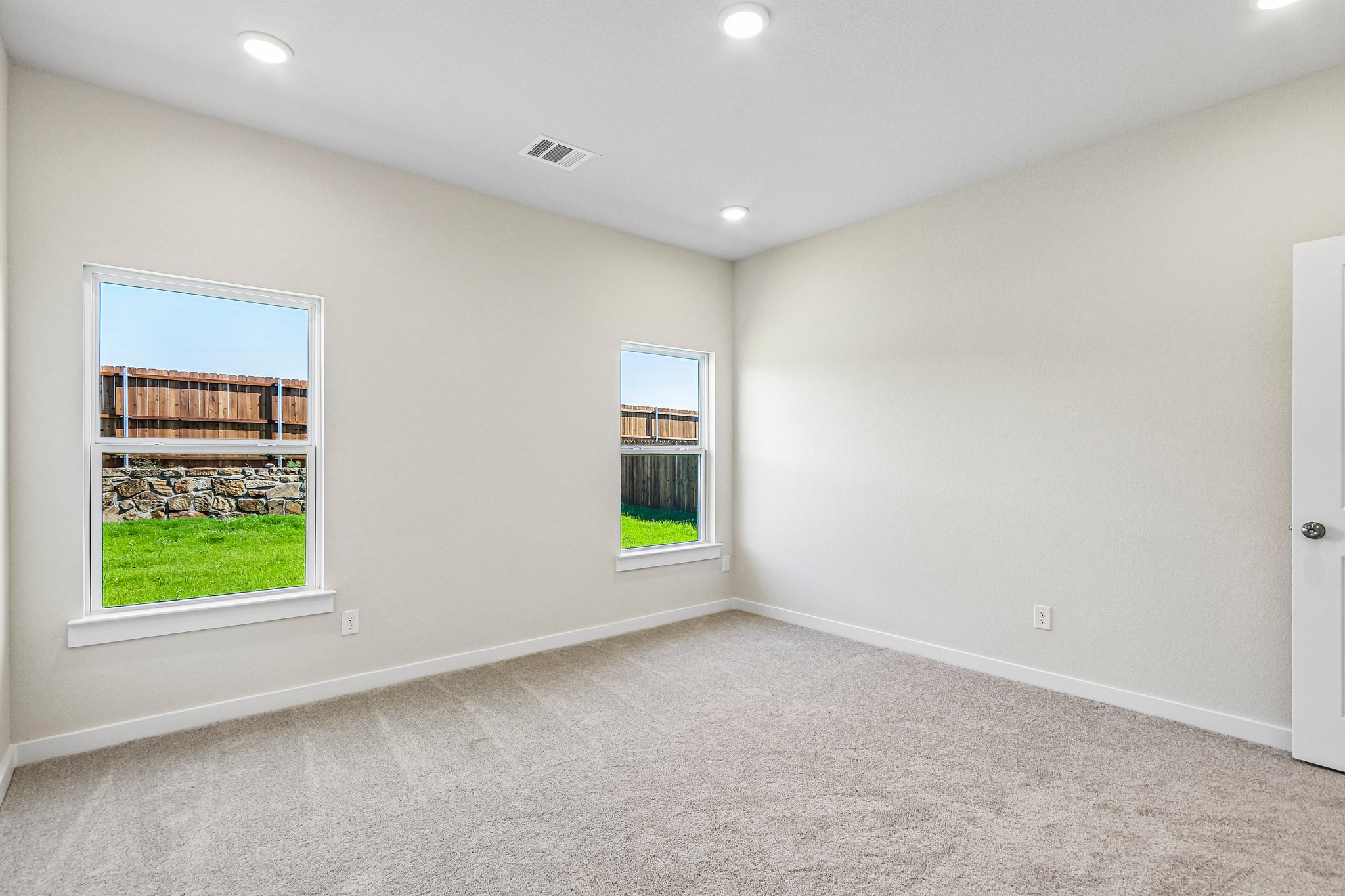 A room with a window and a door.