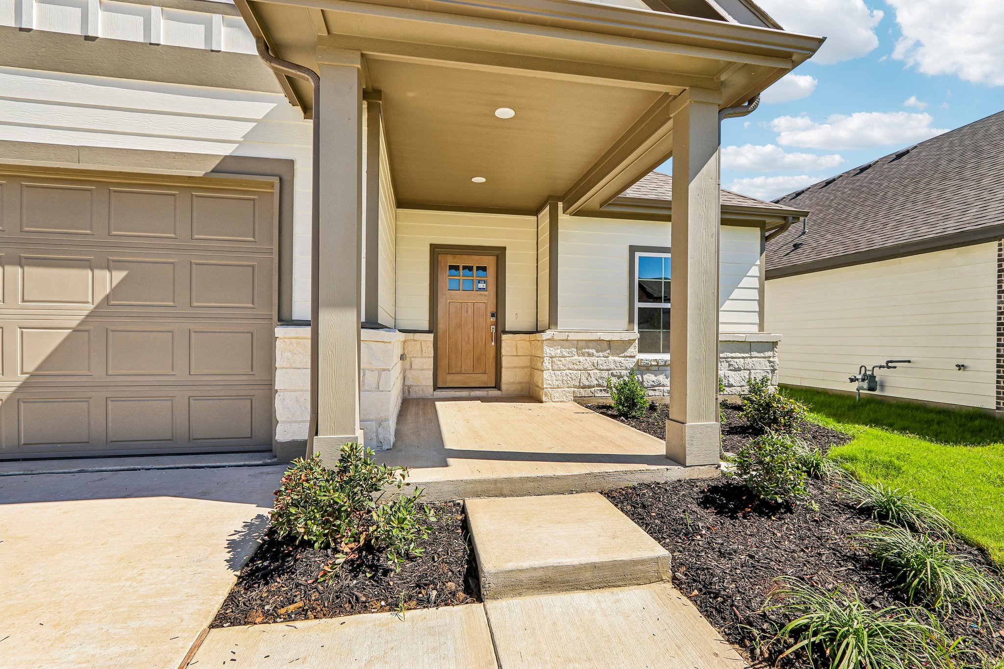 A house with a garage and a door.