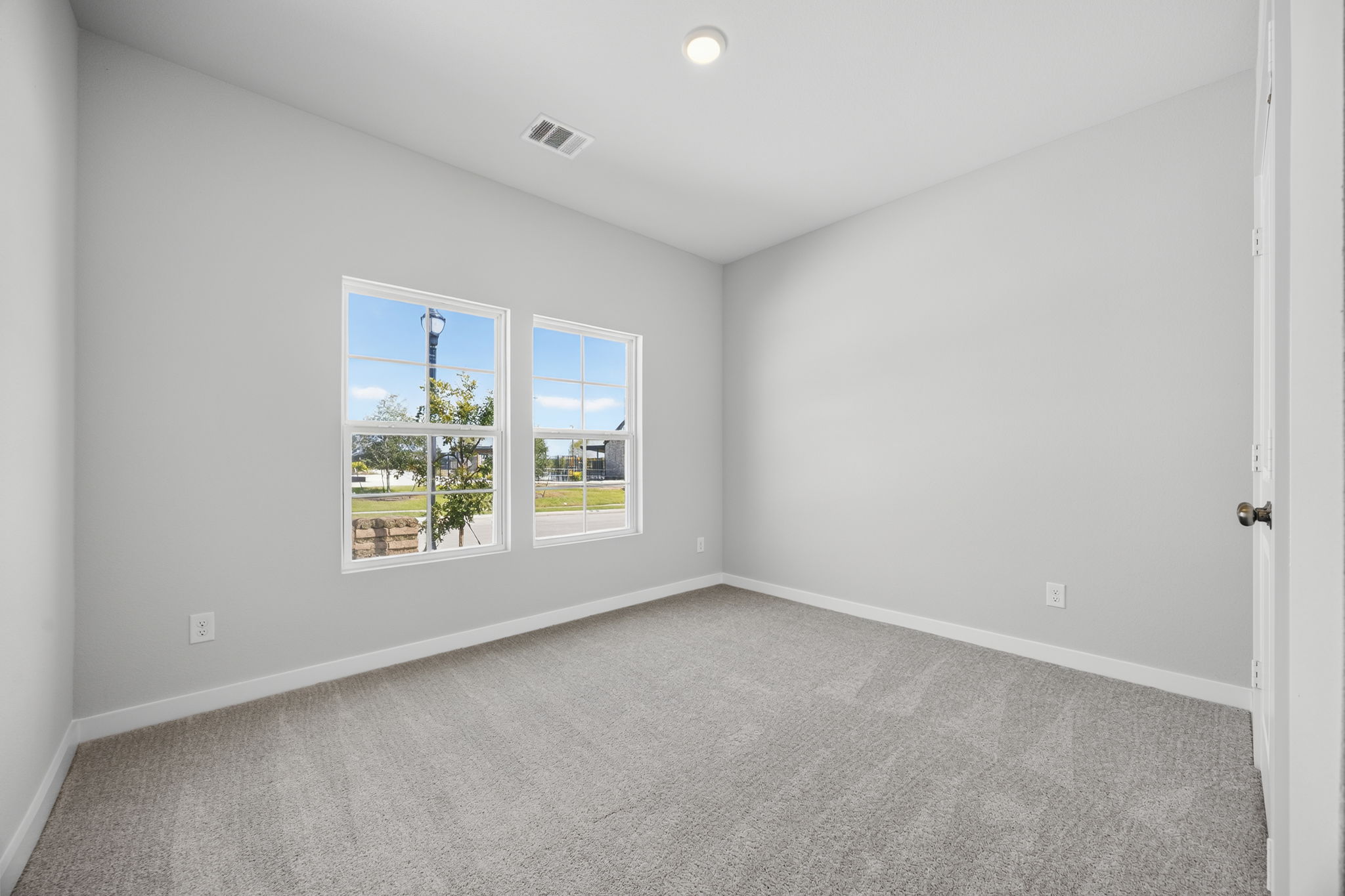A room with a window and a door.