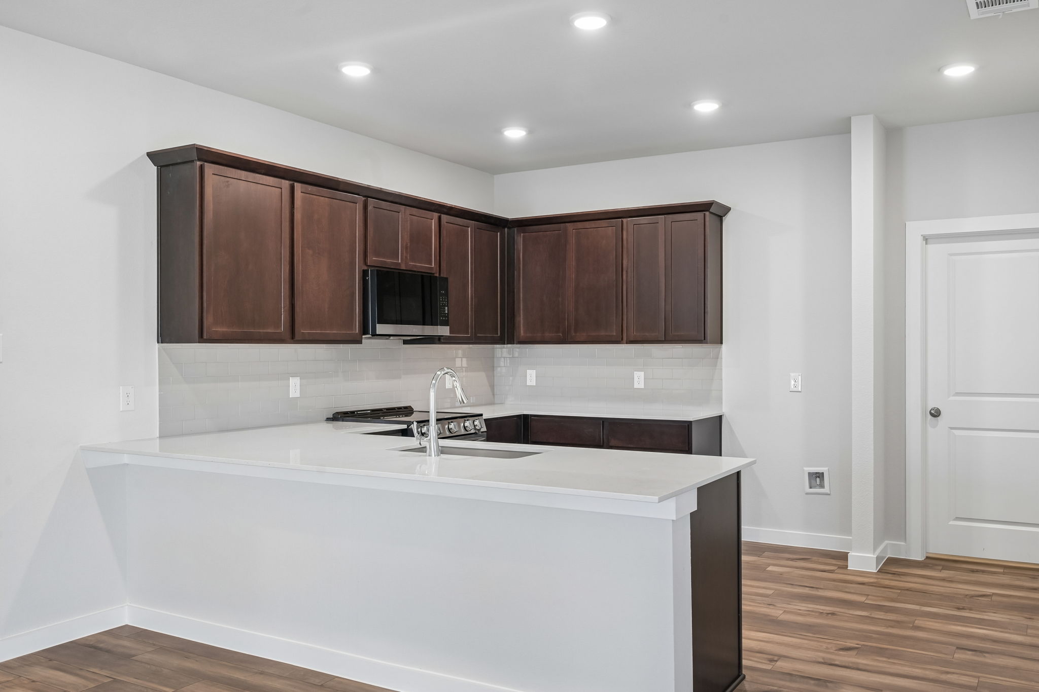 A kitchen with wooden cabinets.
