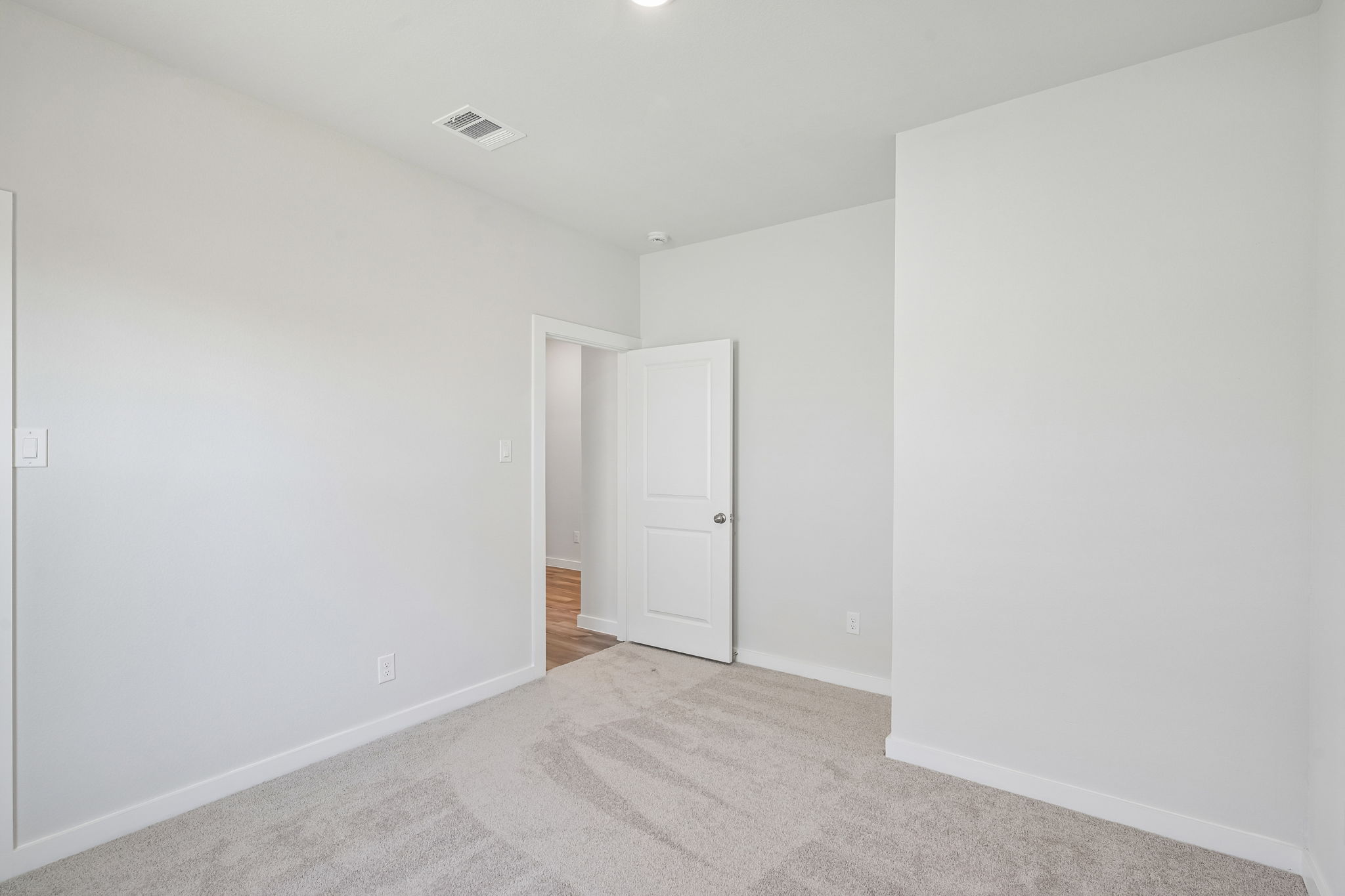 A hallway with white doors.