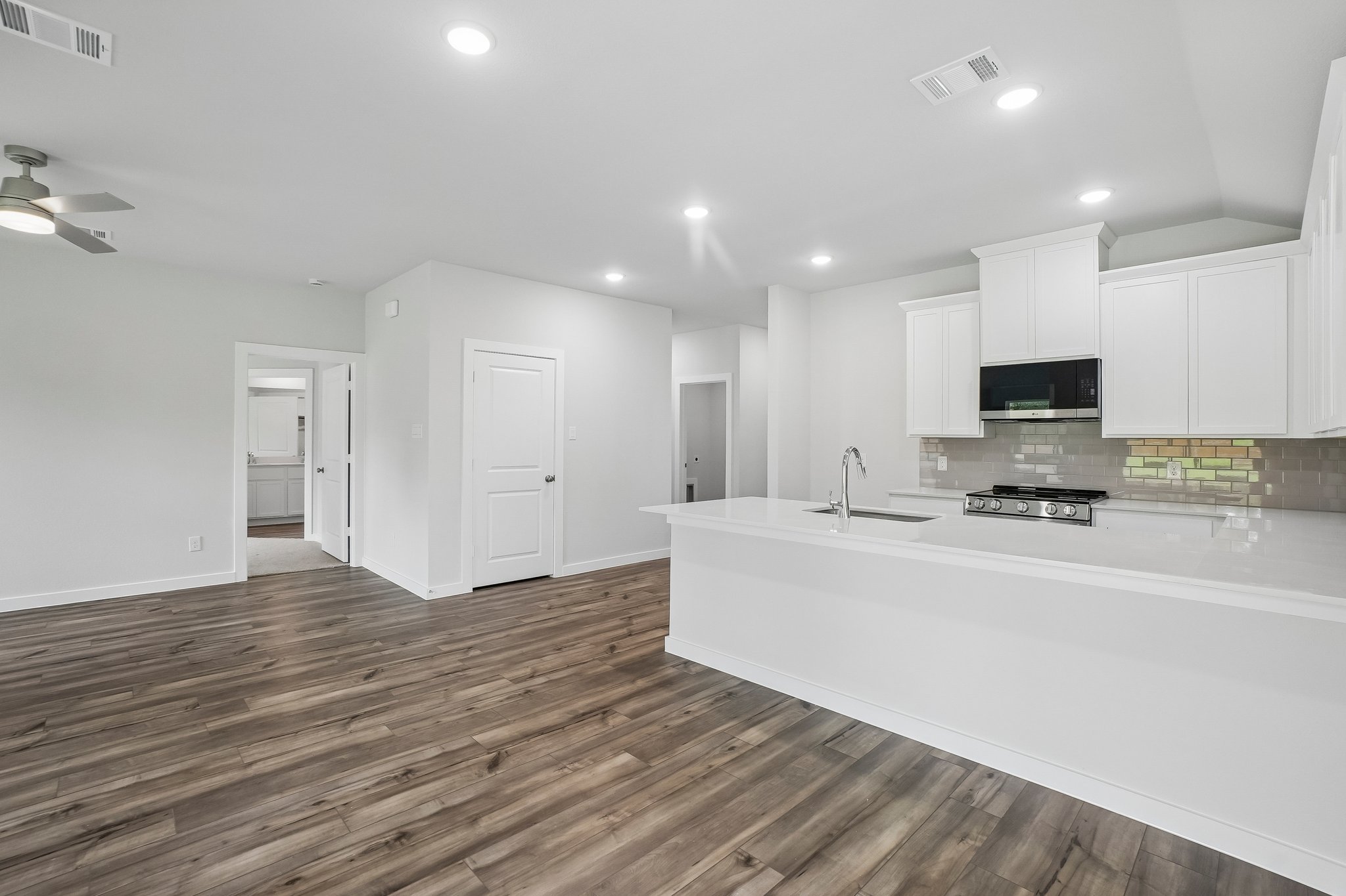 A kitchen with white cabinets.