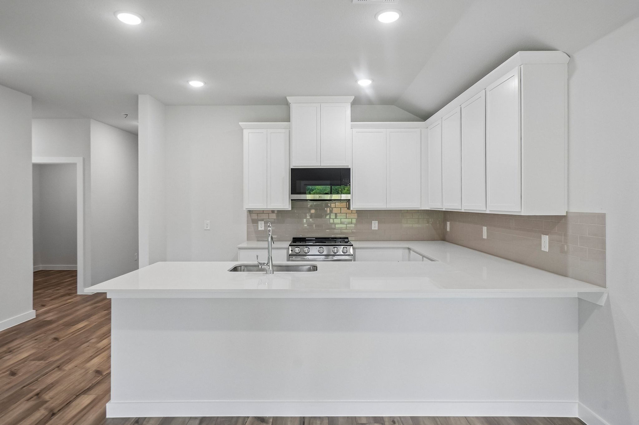 A kitchen with white cabinets.