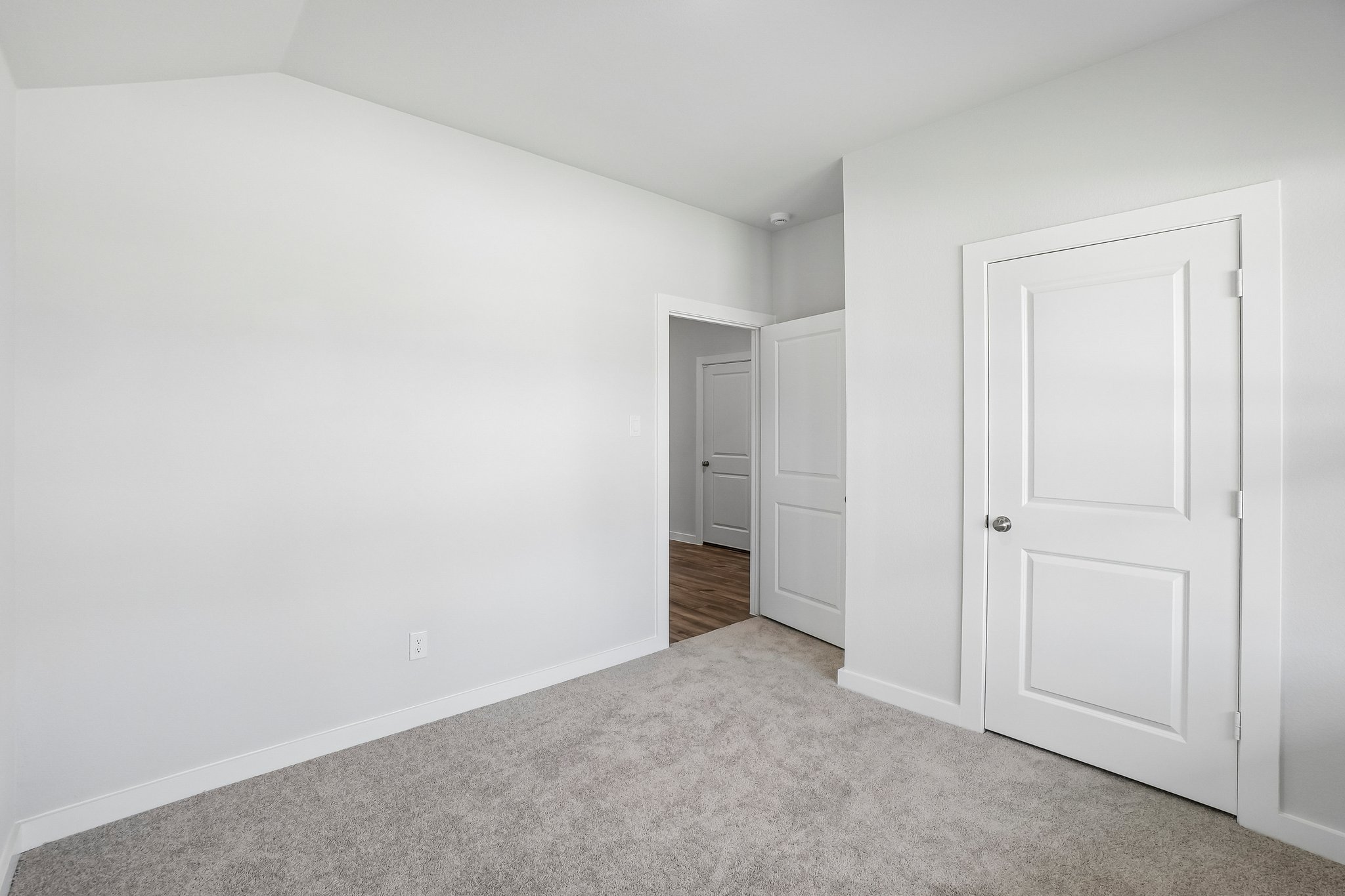 A hallway with white doors.