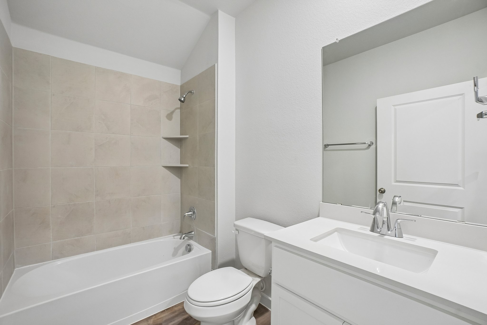 A bathroom with a tub sink and toilet.