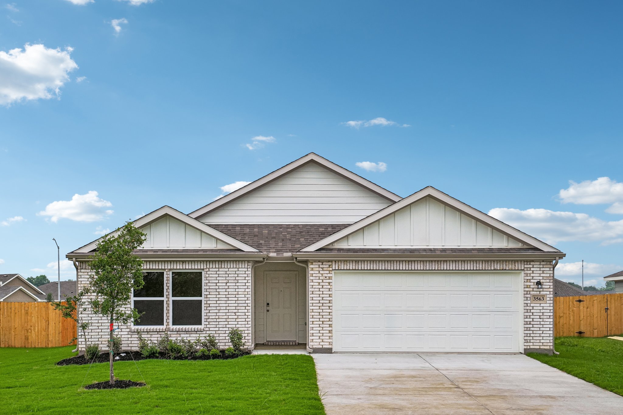 A house with a garage with American Gothic House in the background.