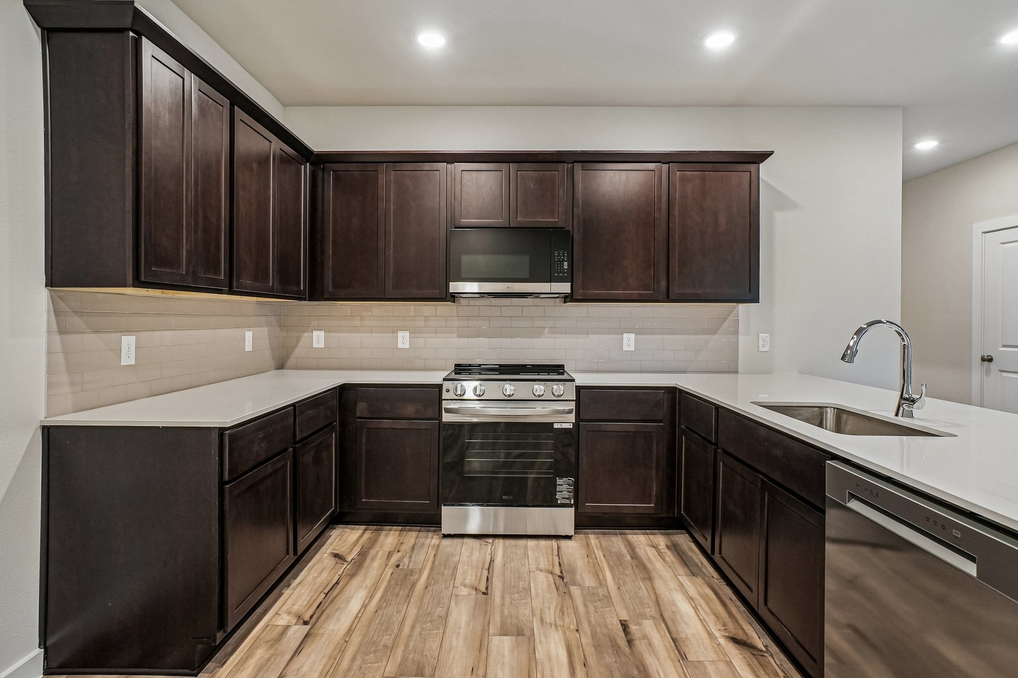 A kitchen with wooden cabinets.