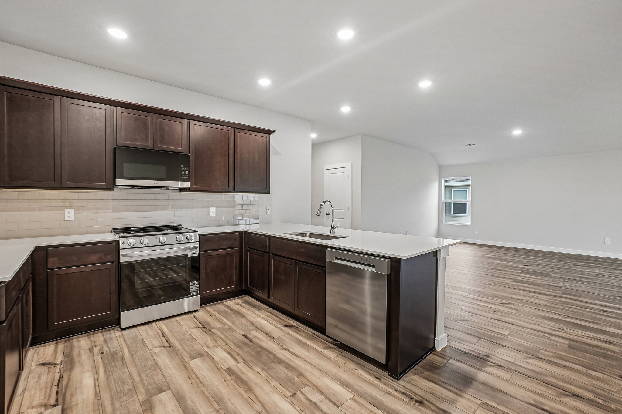 A kitchen with wooden cabinets.